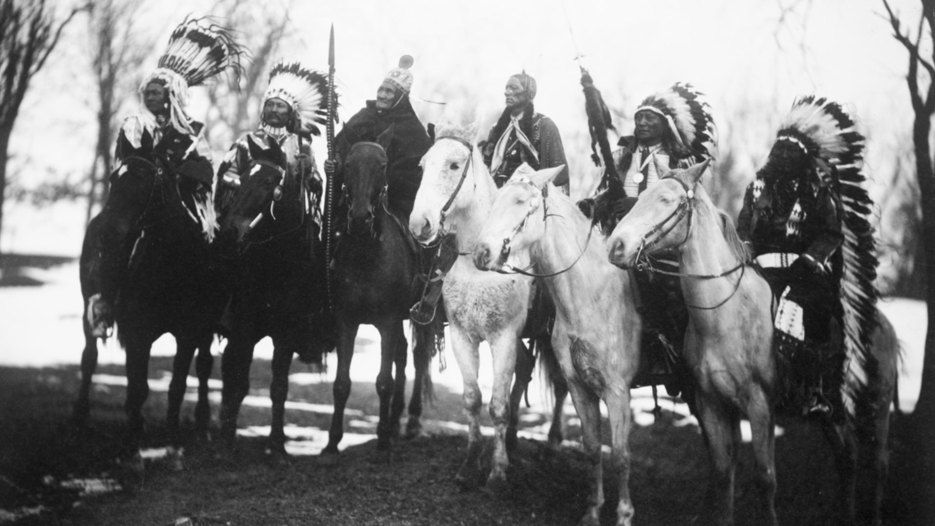 Six tribal leaders (l to r) Little Plume (Piegan), Buckskin Charley (Ute), Geronimo (Chiricahua Apache), Quanah Parker (Comanche), Hollow Horn Bear (Brulé Sioux), and American Horse (Oglala Sioux) on horseback in ceremonial attire