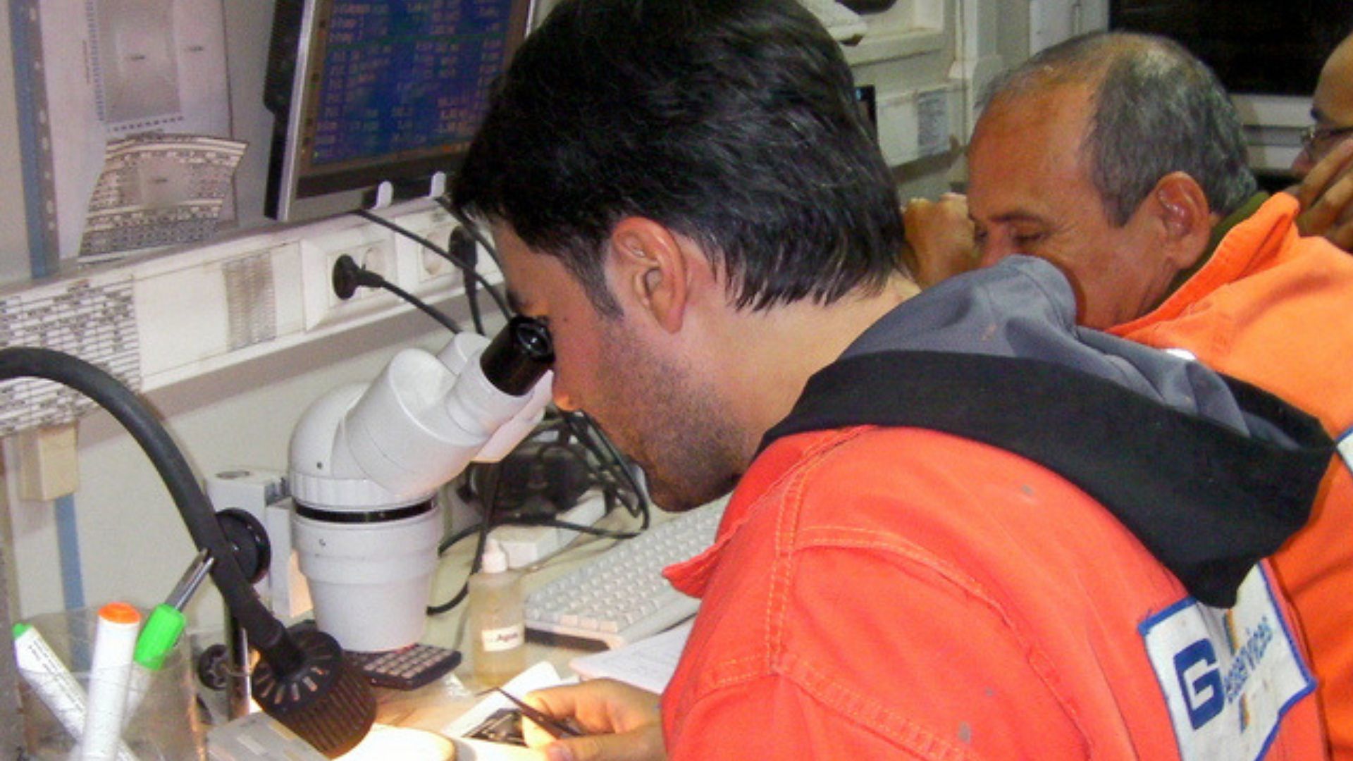 Mud Loggers and Data Engineers working inside a mud logging cabin on an onshore well