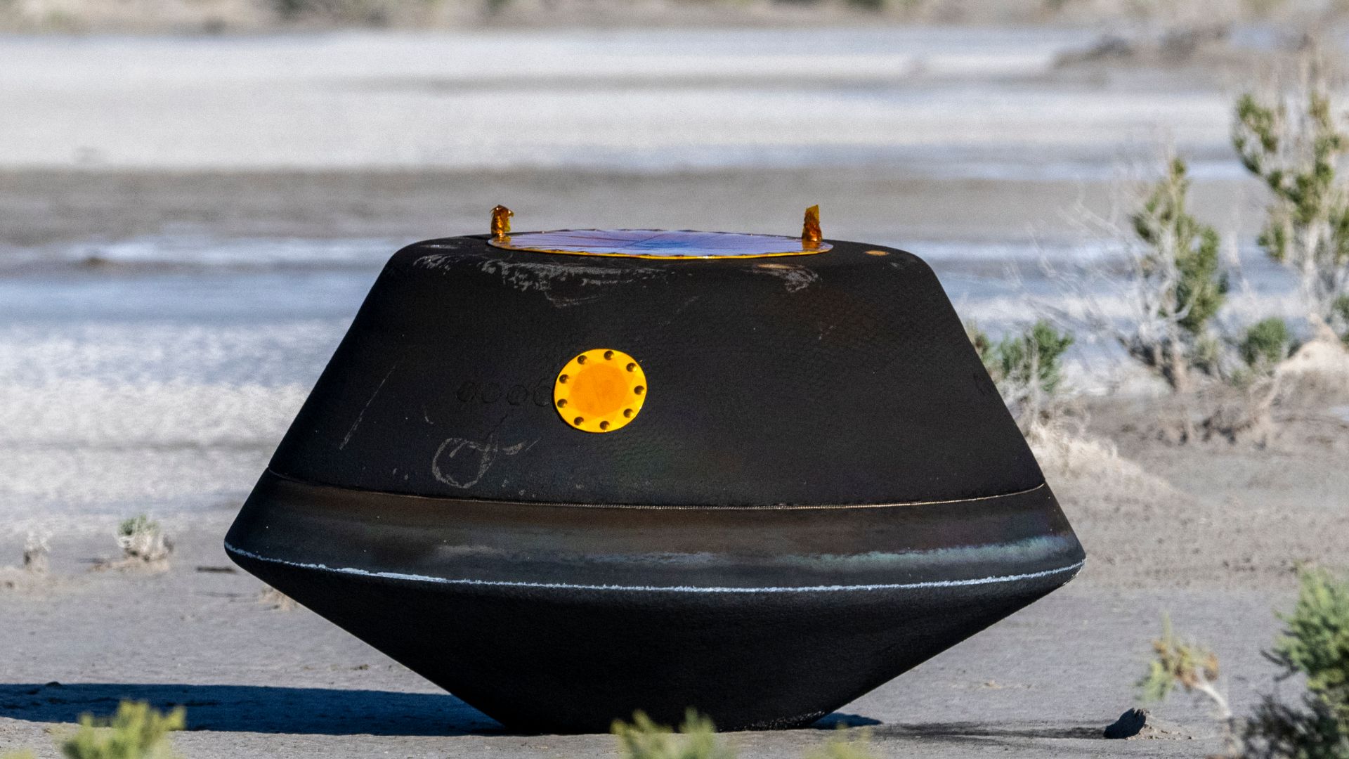 The sample return capsule from NASA’s OSIRIS-REx mission is seen shortly after touching down in the desert, Sunday, Sept. 24, 2023, at the Department of Defense's Utah Test and Training Range. The sample was collected from the asteroid Bennu in October 20
