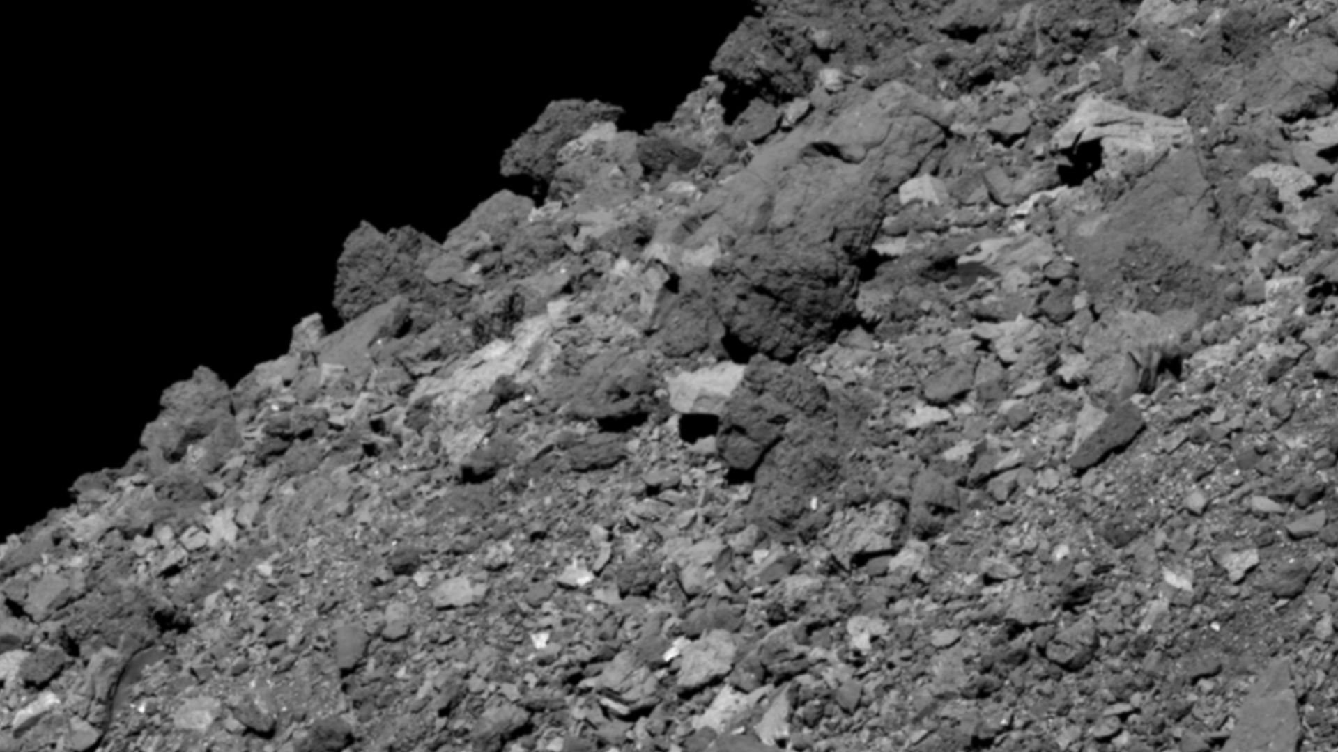 This image shows asteroid Bennu’s boulder-covered surface. It was taken by the PolyCam camera on NASA’s OSIRIS-REx spacecraft on April 11, 2019, from a distance of 2.8 miles (4.5 km). The field of view is 211 ft (64.4 m), and the large boulder in the uppe