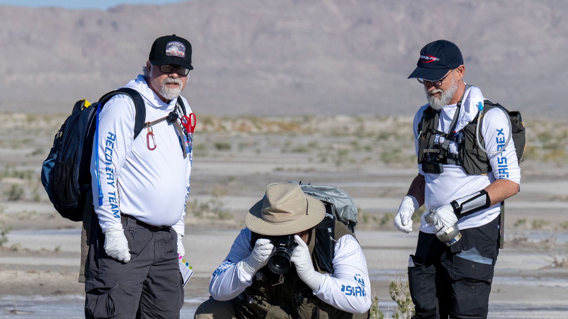 From left to right, NASA Sample Return Capsule Science Lead Scott Sandford, NASA Astromaterials Curator Francis McCubbin, and University of Arizona OSIRIS-REx Principal Investigator Dante Lauretta, collect science data, Sunday, Sept. 24, 2023, shortly aft