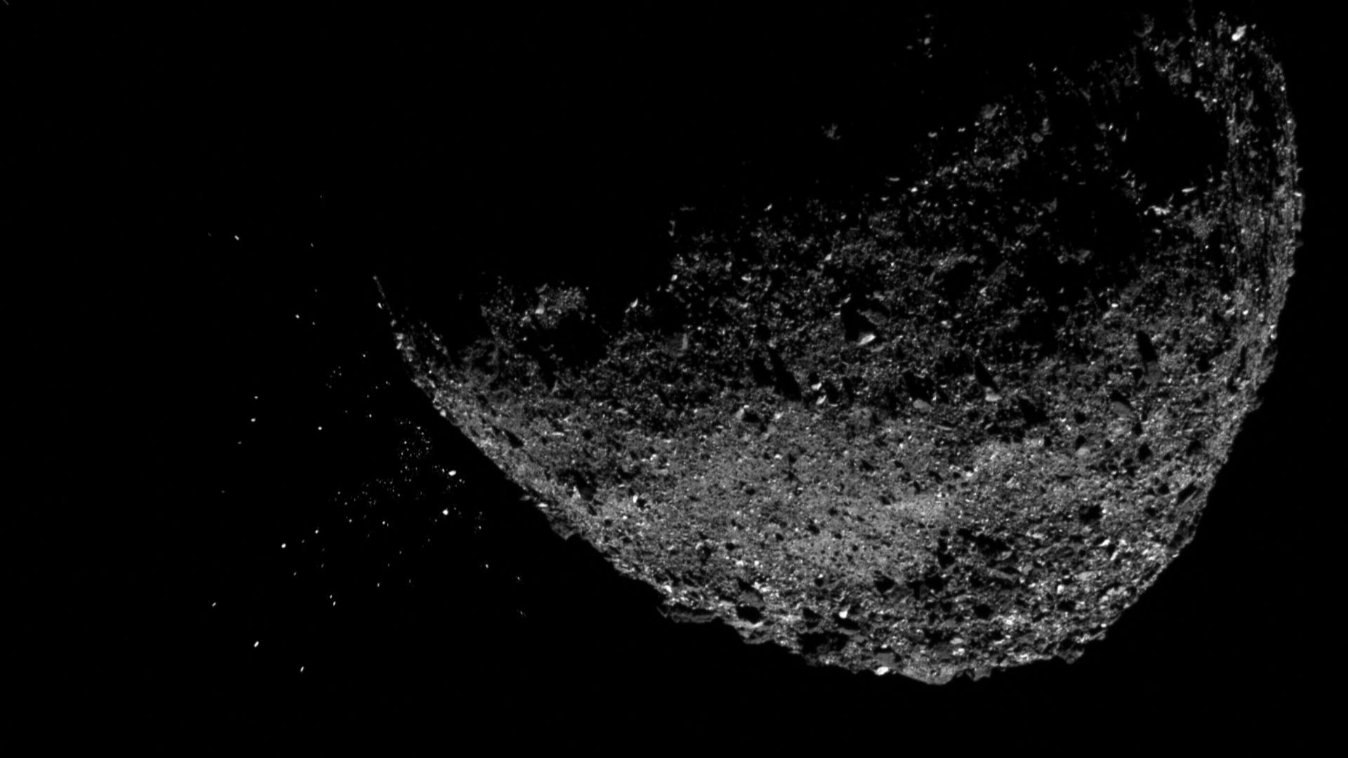 This view of asteroid Bennu ejecting particles from its surface on Jan. 6, 2019, was created by combining two images taken by the NavCam 1 imager aboard NASA's OSIRIS-REx spacecraft: a short exposure image, which shows the asteroid clearly, and a long-exp