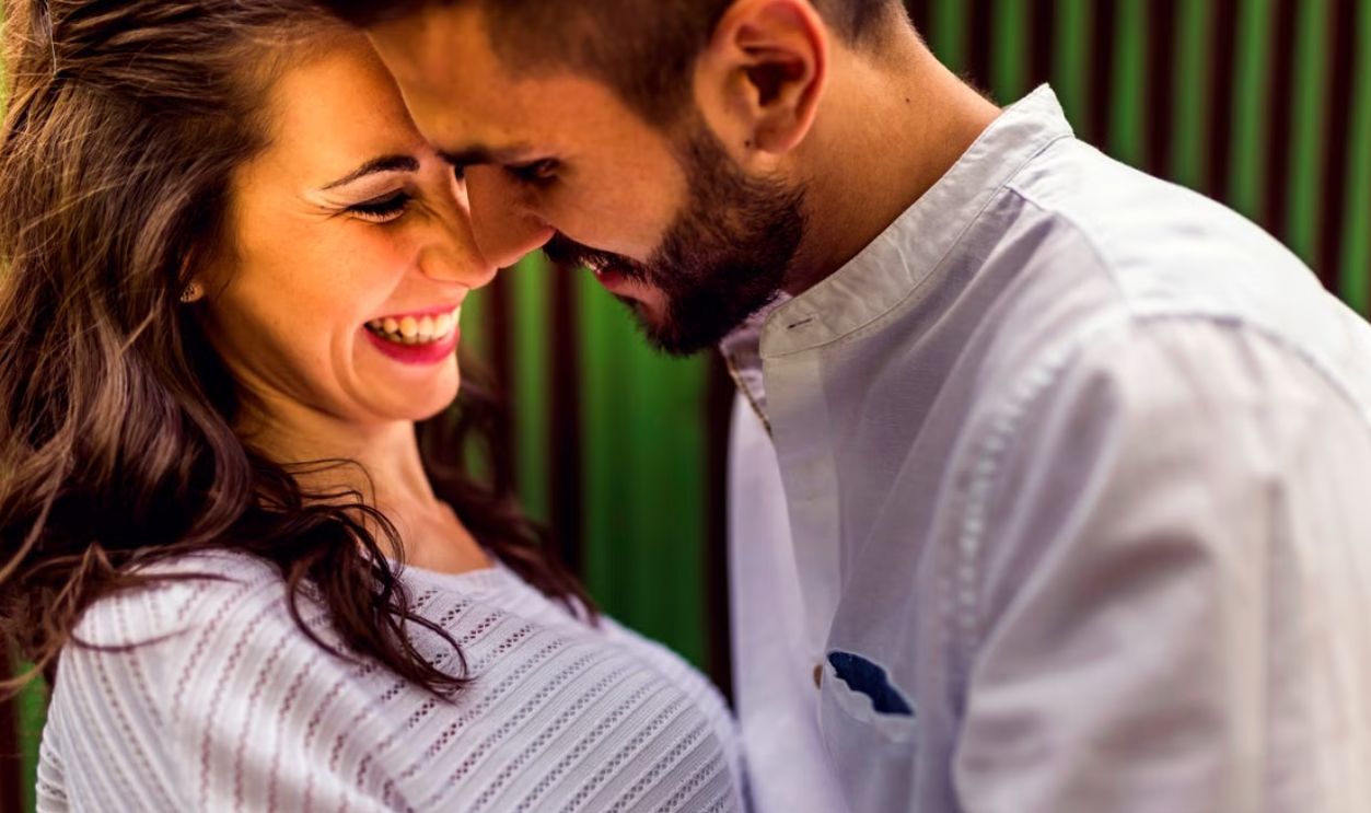 Close-up of a happy couple laughing and embracing outdoors in Toledo, Spain