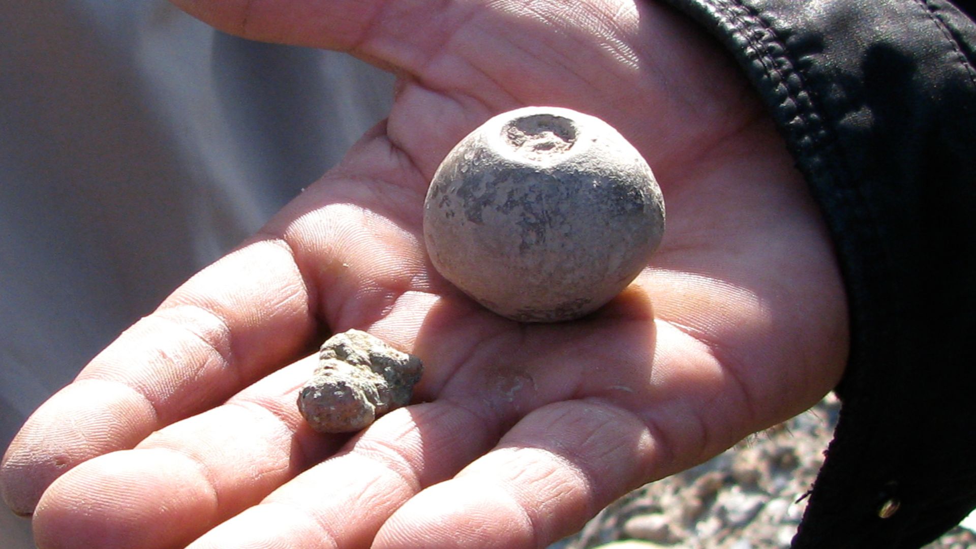 Here's the artifact the guy dug up...
Pottery shards from the big mound near Jalalabad.  Dave and I have been unable to get more information about it.  
It's clearly man-made.  Look at it in the satellite imagery (link below).  Seriously.  There used to b