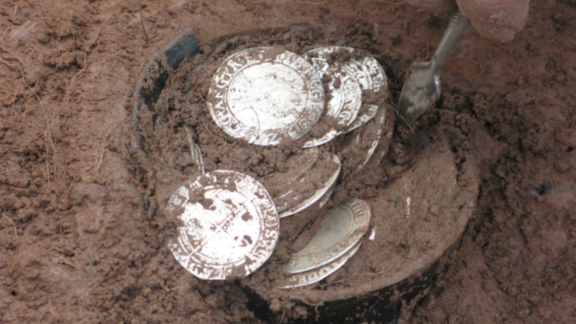 Bitterley, Shropshire (2011 T89)
Hoard of Post-Medieval coins and their container
This hoard was found at Bitterley, Shropshire on 17 February 2011 by a metal-detector user. The finder did not remove the hoard from the ground himself, but notified the Por