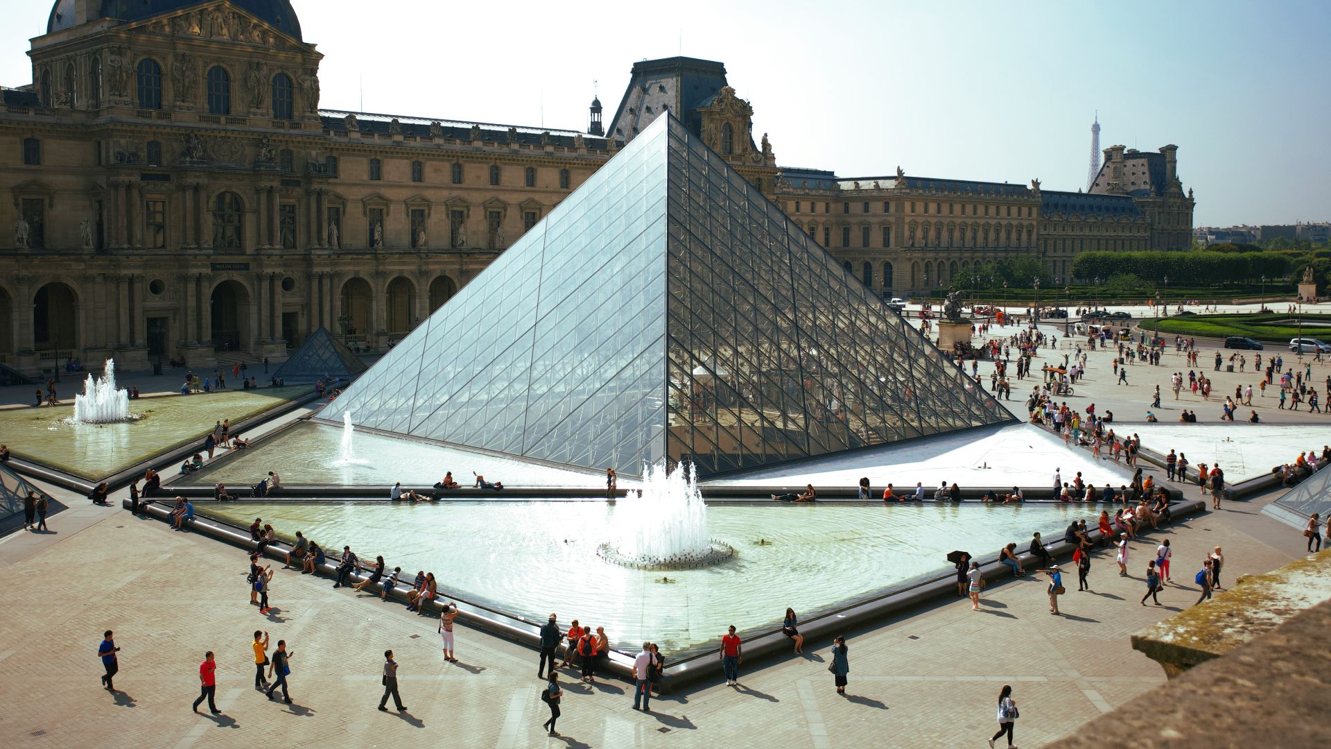 people walking around pyramid landmark