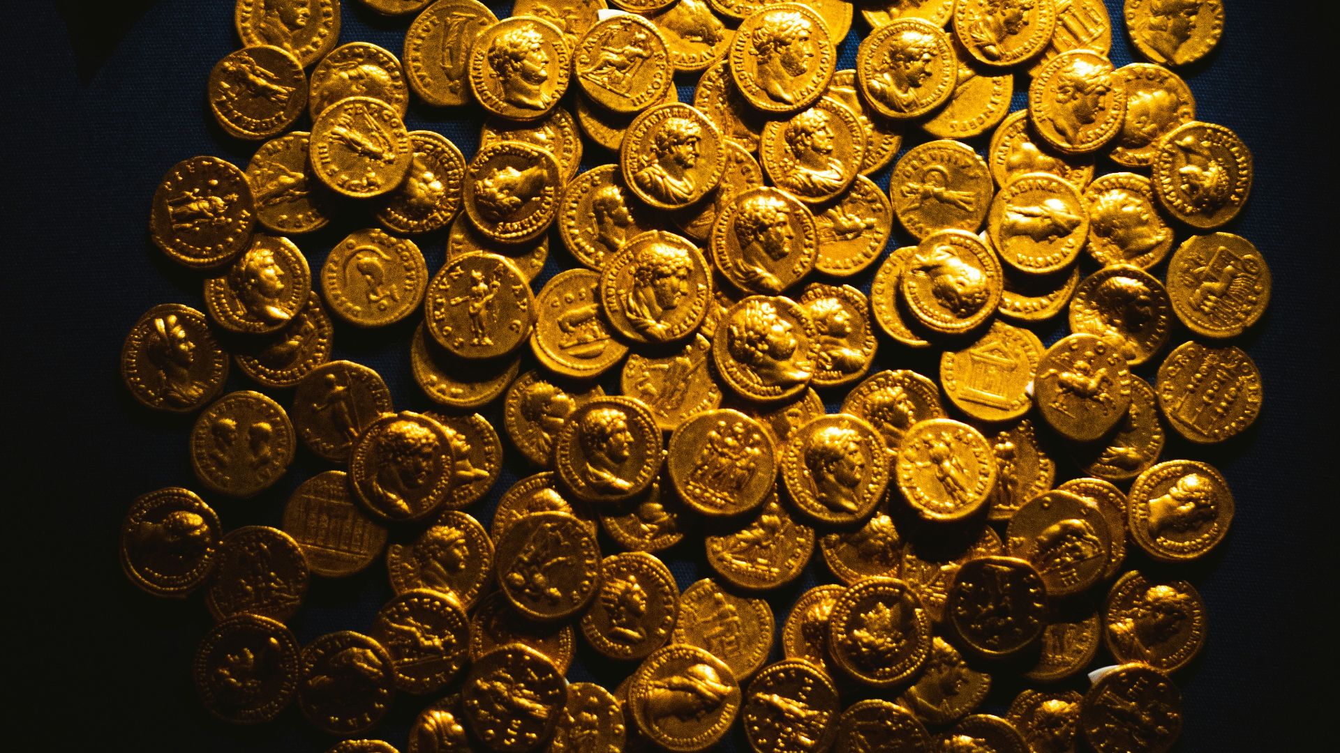 A pile of ancient gold coins with pottery shards.