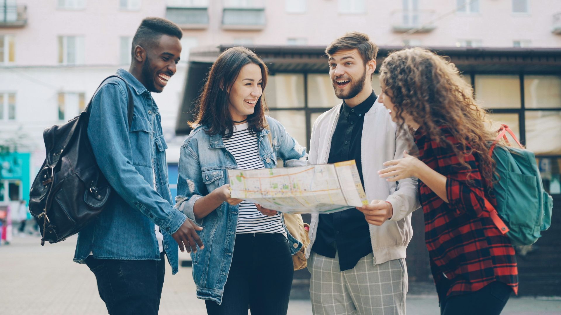 Friends look at a map, likely planning their trip.