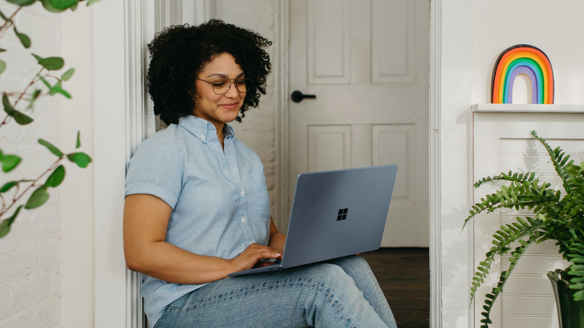 a woman sitting on the floor using a laptop