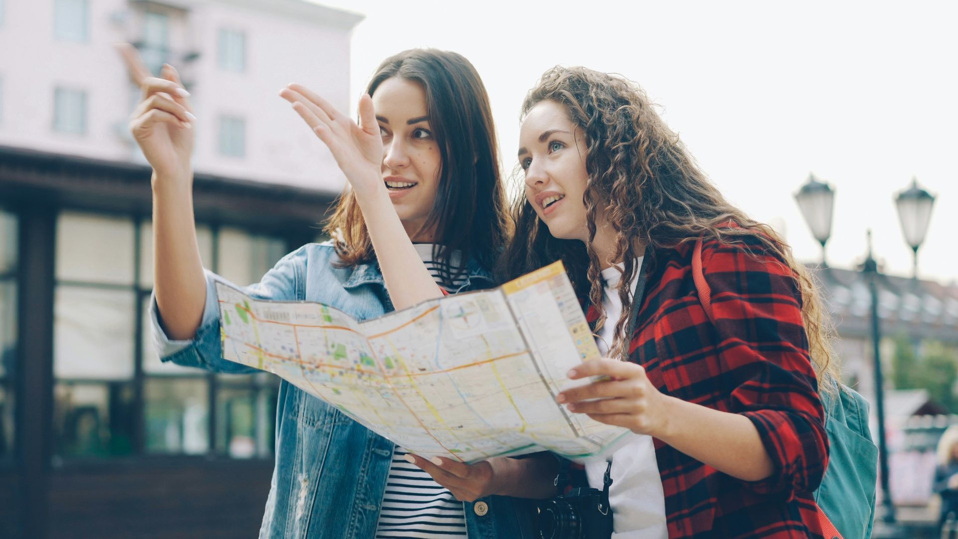 Two women use a map to find directions.