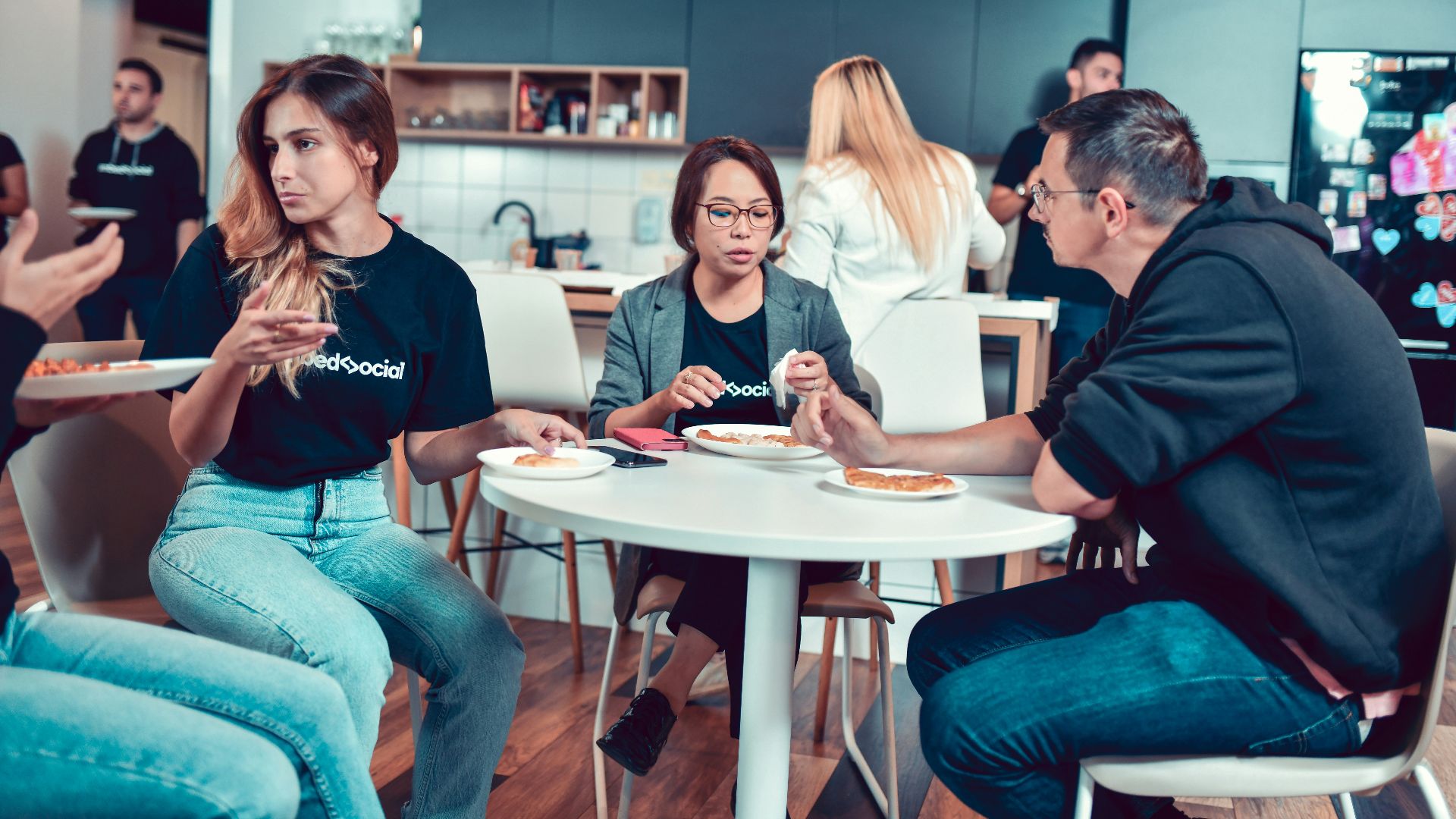 a group of people sitting around a table eating food
