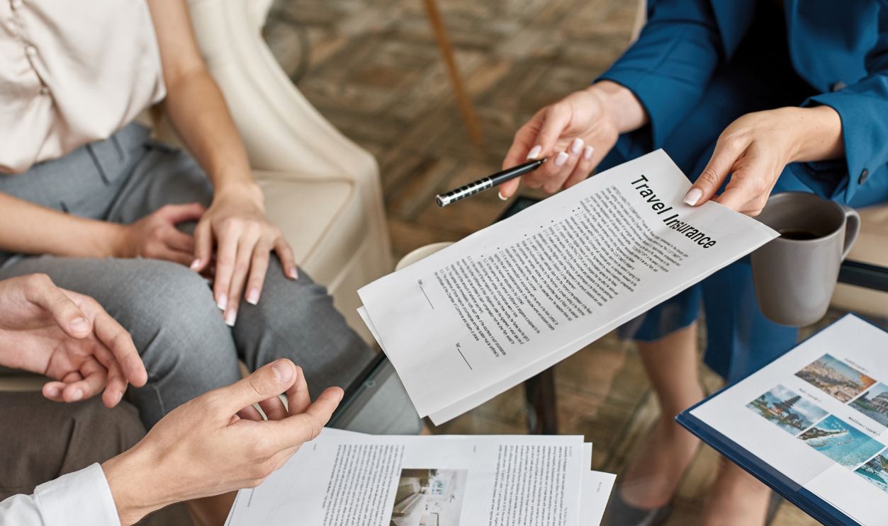 Partial image of female tourist agent giving travel insurance to man near his girlfriend in travel agency. Service and communication with clients. Vacation, tourism, weekend and journey. Trip booking