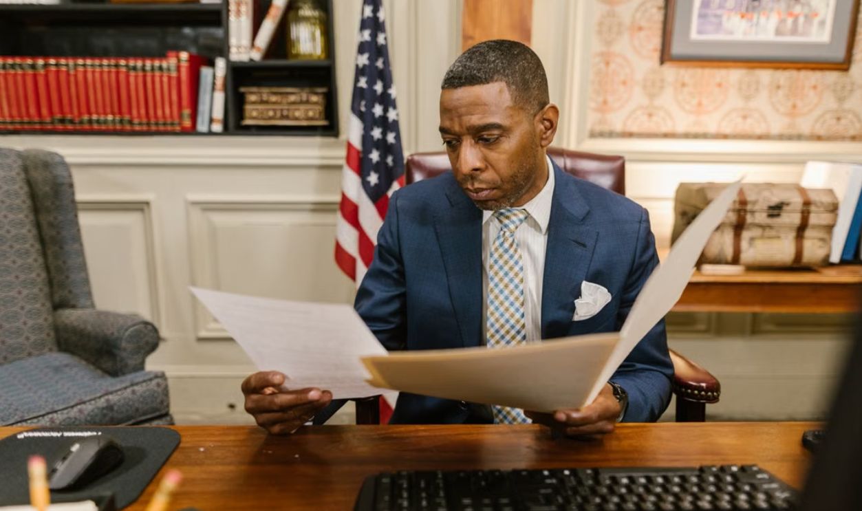 A lawyer reading documents in an office setting, conveying professionalism and focus