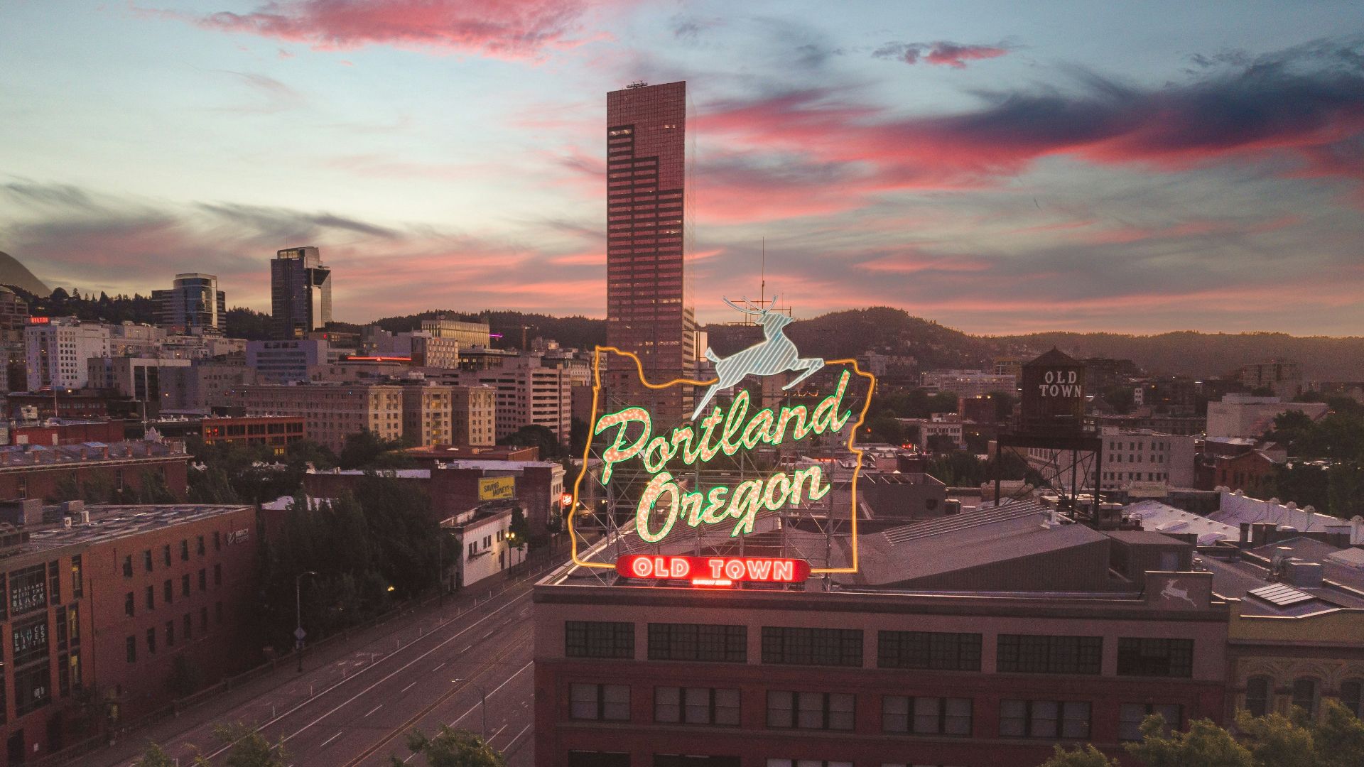 a large neon sign on top of a building