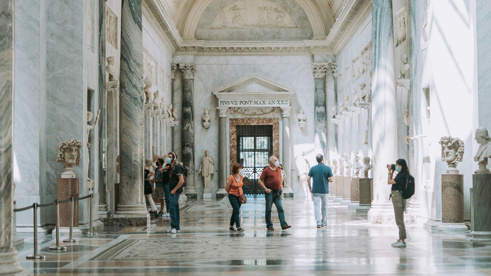 people walking inside white concrete building