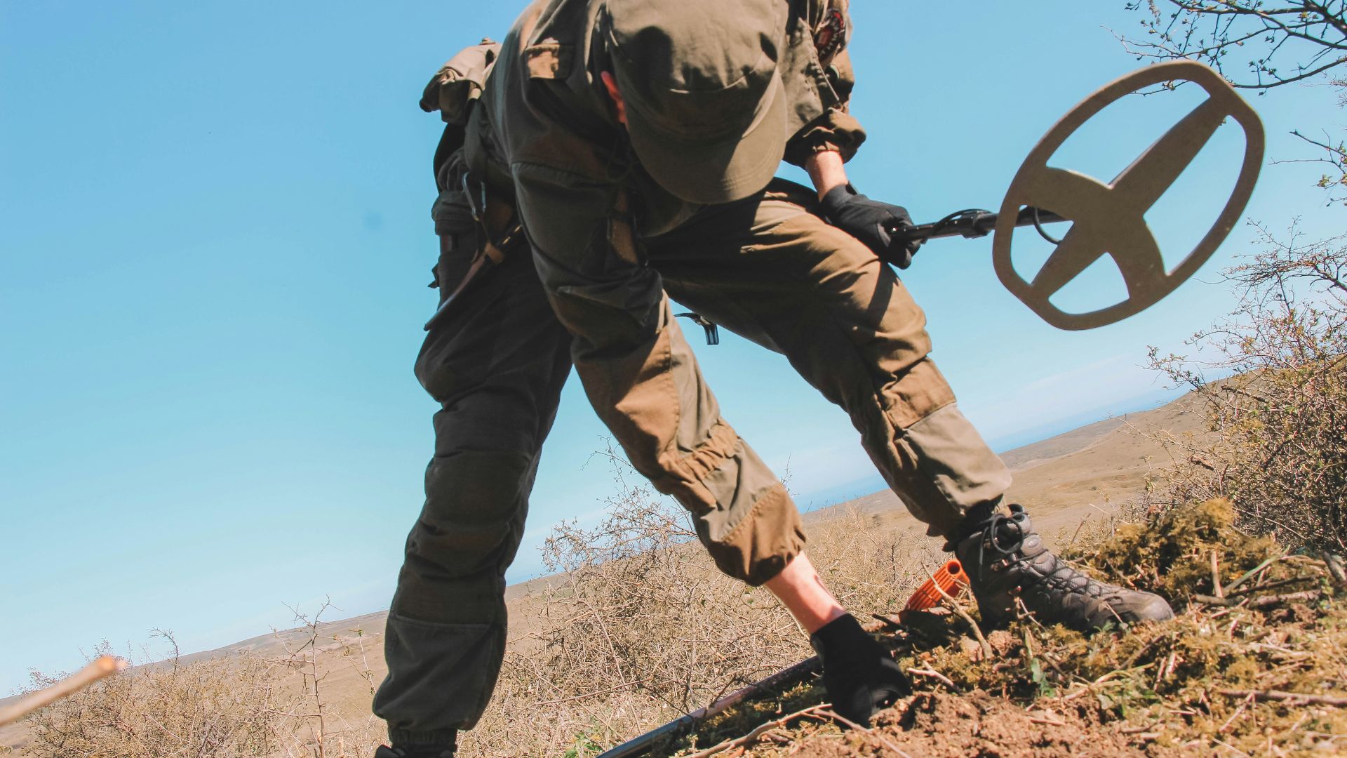 officer holding metal detector