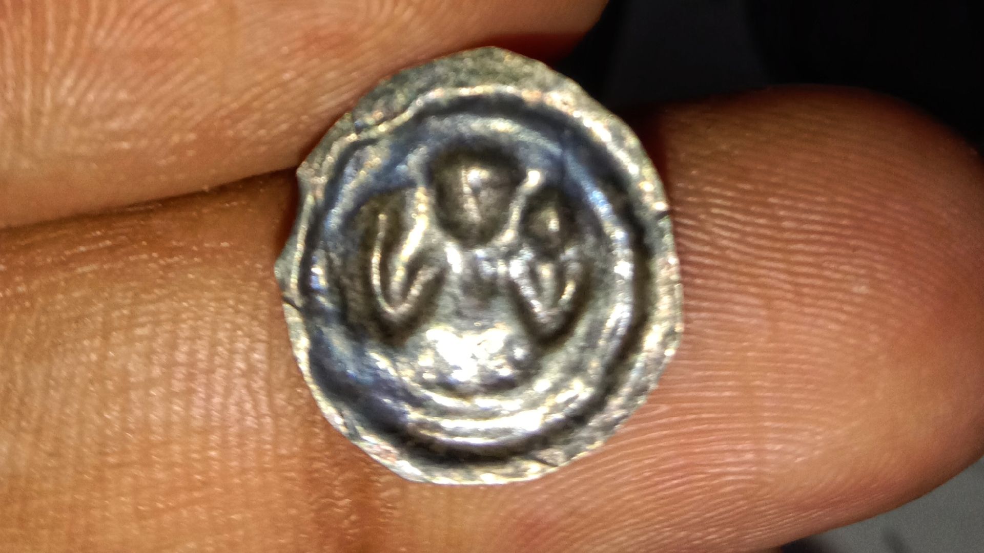 Reverse of a Medieval European Bracteate (coin) made out of silver. Photo taken by Yogabrata Chakraborty from personal collection, on December 24, 2022.