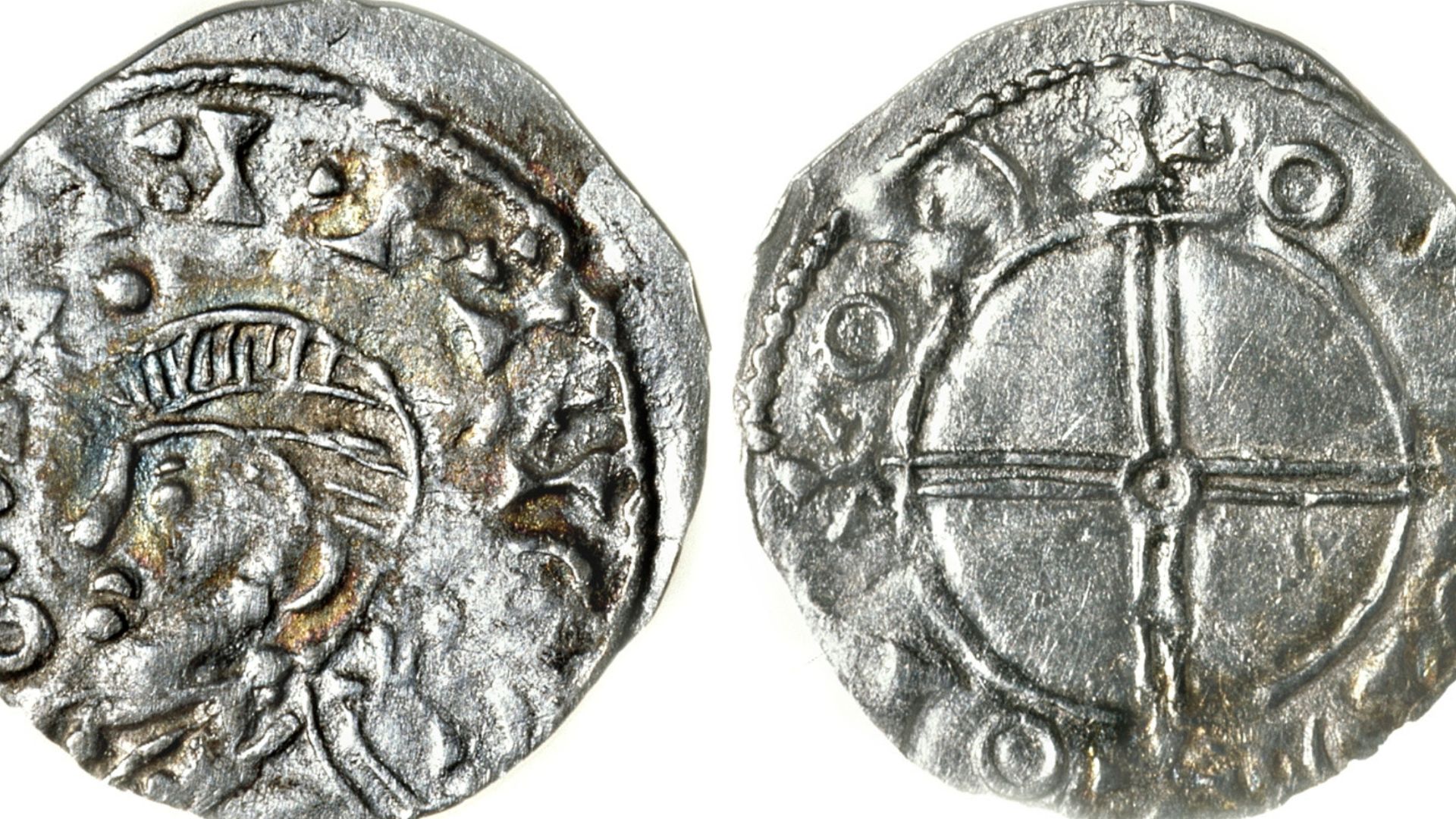 Norwegian silver penning minted during reign of Magnus Barefoot; circa 1093-1103 AD. Obverse features bust facing left surrounded by an unreadable inscription, reverse shows double cross in the center with a small circle in the middle in a solid ring. Unr