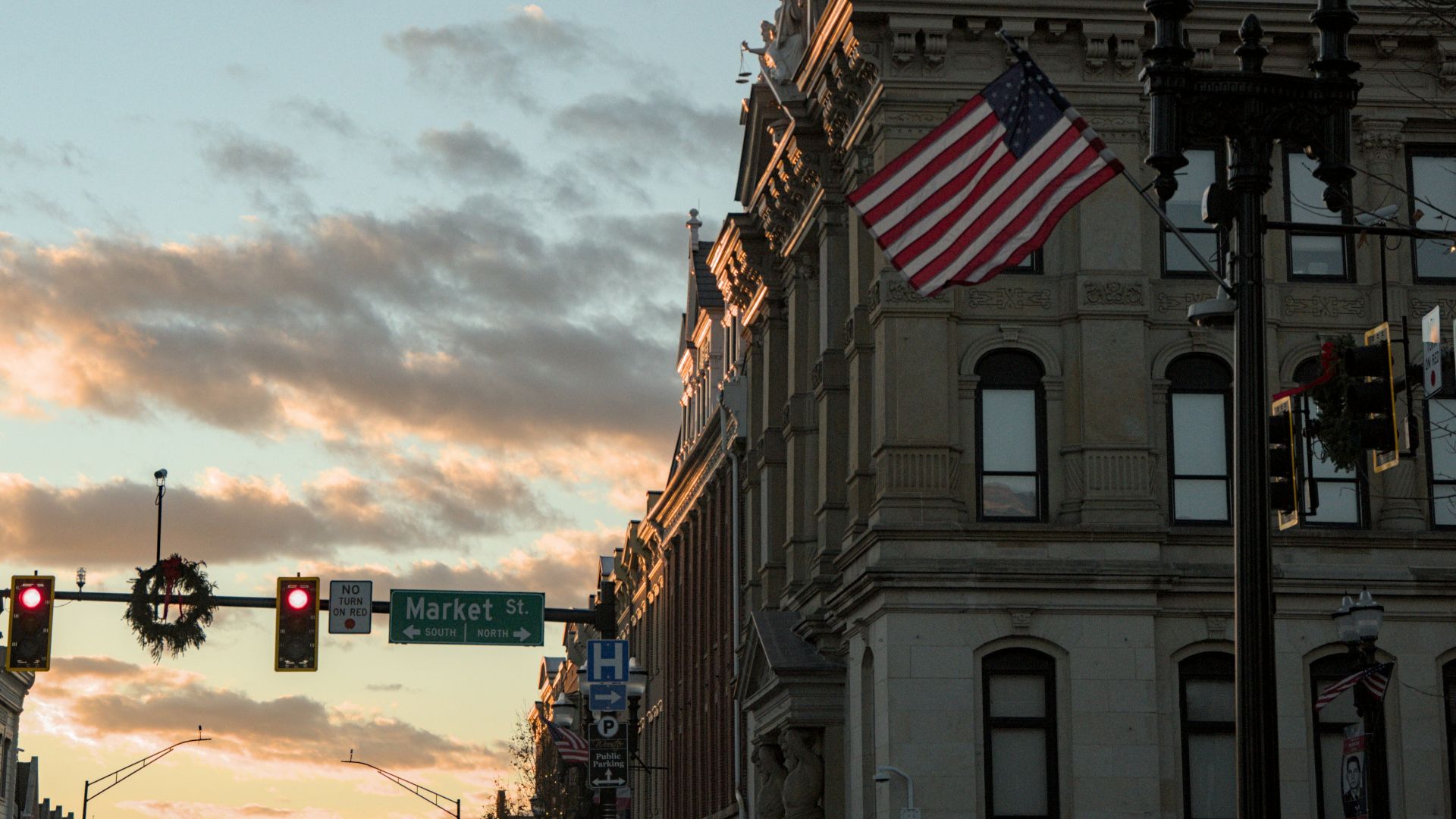 American flag flies over historic building at sunset