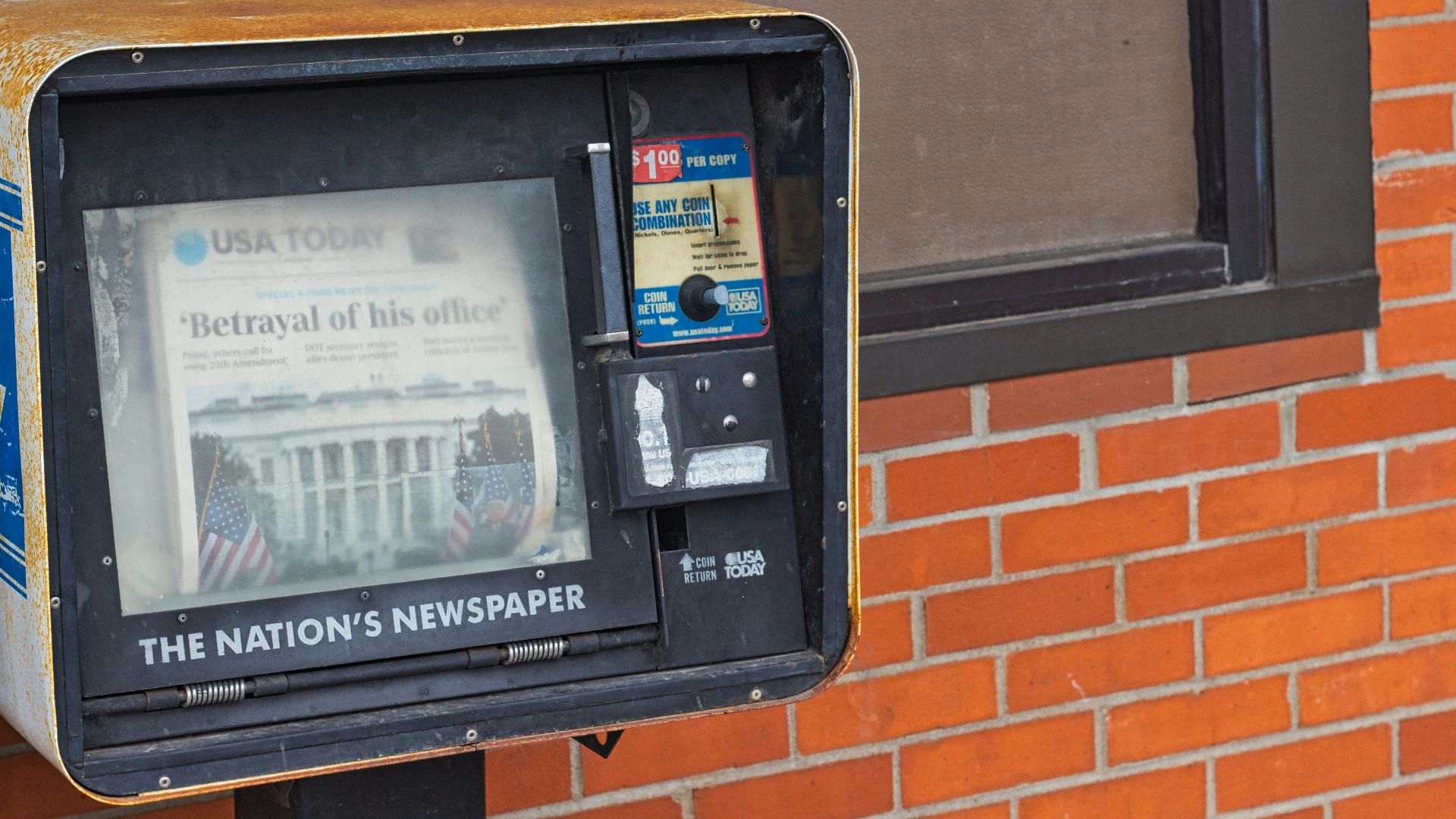 black digital device on brown brick wall