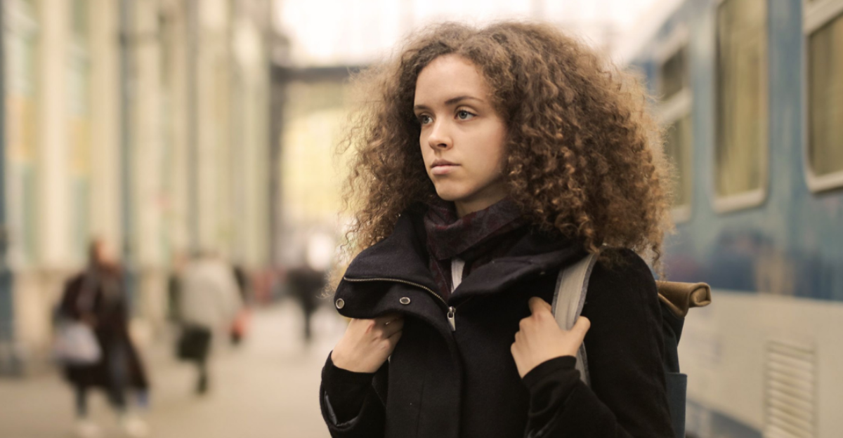 woman-in-black-coat-standing-standing-beside-subway