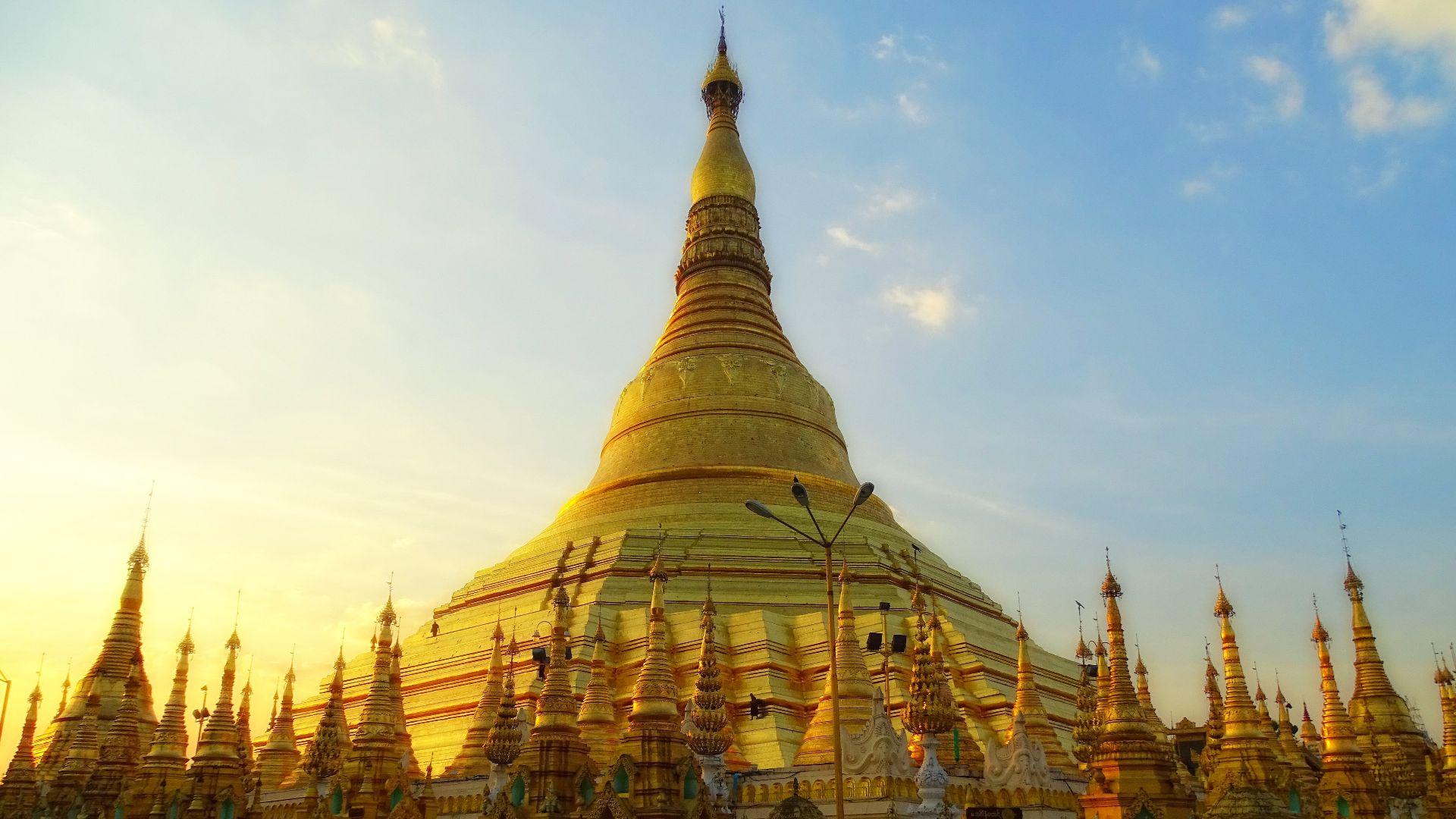 The south-eastern side of Shwedagon Pagoda. A monk is walking on the facade, demonstrating the large scale of the stupa.