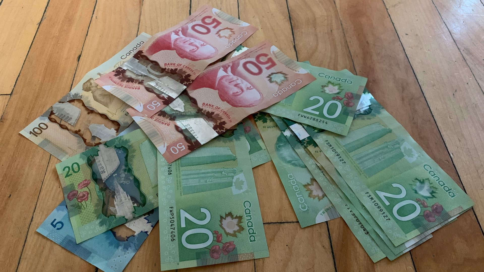 10 and 20 banknotes on brown wooden table
