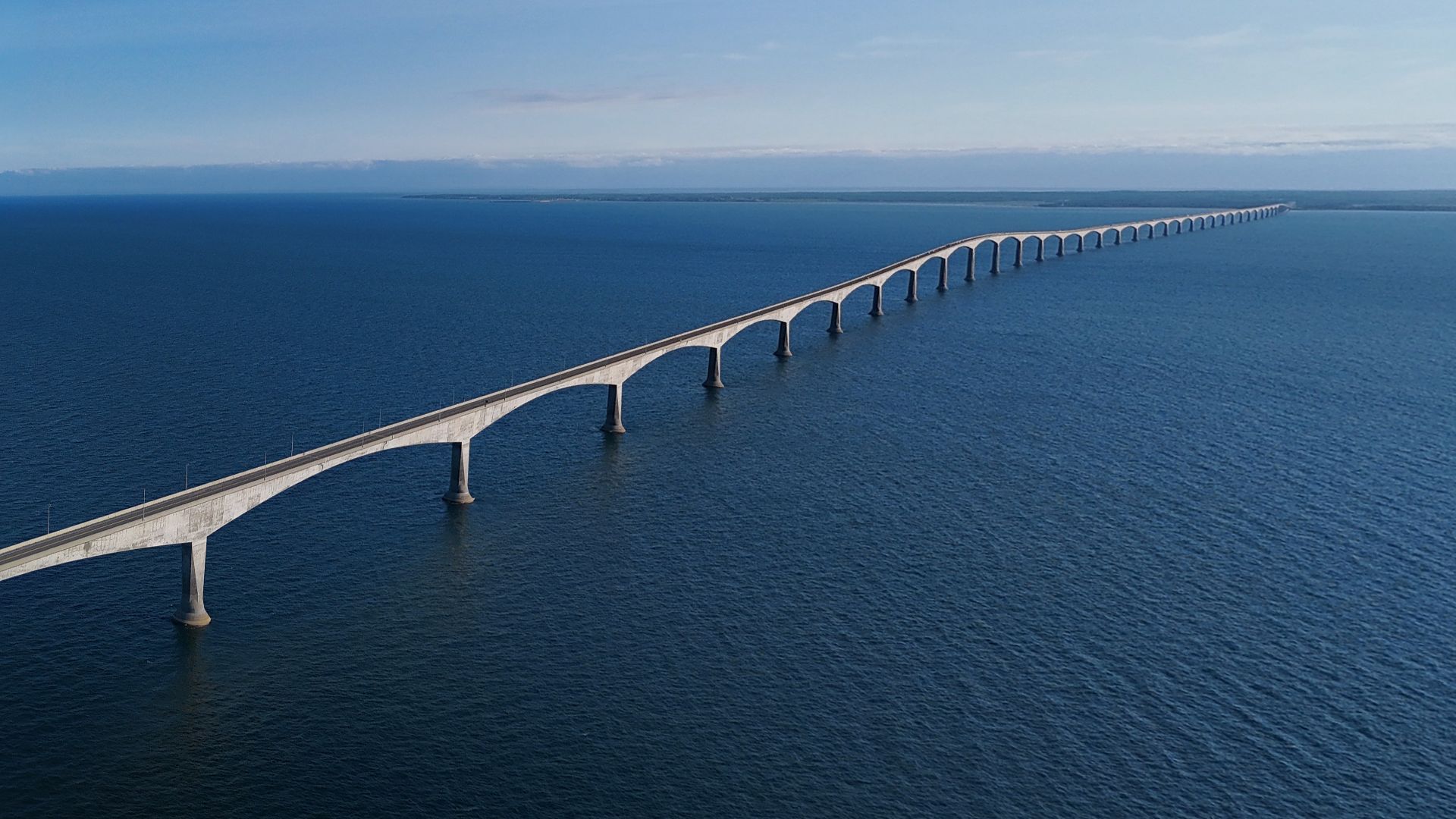 Aerial view of the Confederation Bridge from the Prince Edward Island side, looking southwest across the Northumberland Strait toward Cape Jourimain, New Brunswick.