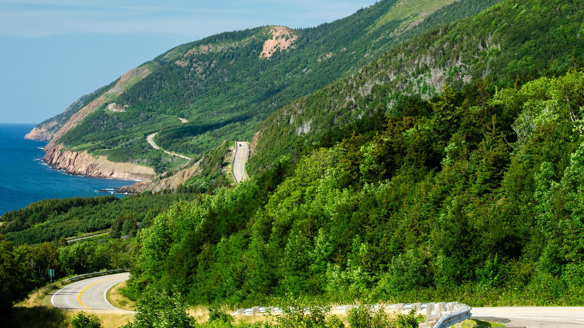 The Cabot Trail winding through the Cape Breton Highlands along the western coast of Cape Breton Island, Nova Scotia, Canada. The scenic highway follows steep coastal mountains overlooking the Gulf of St. Lawrence.