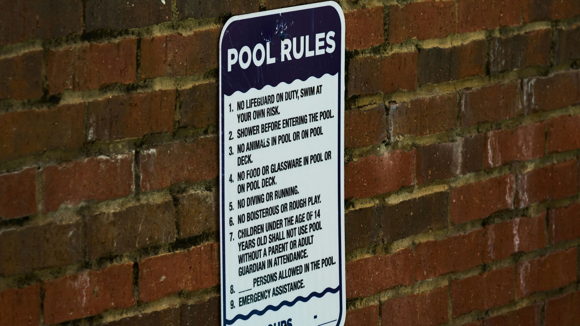 a sign on a brick wall