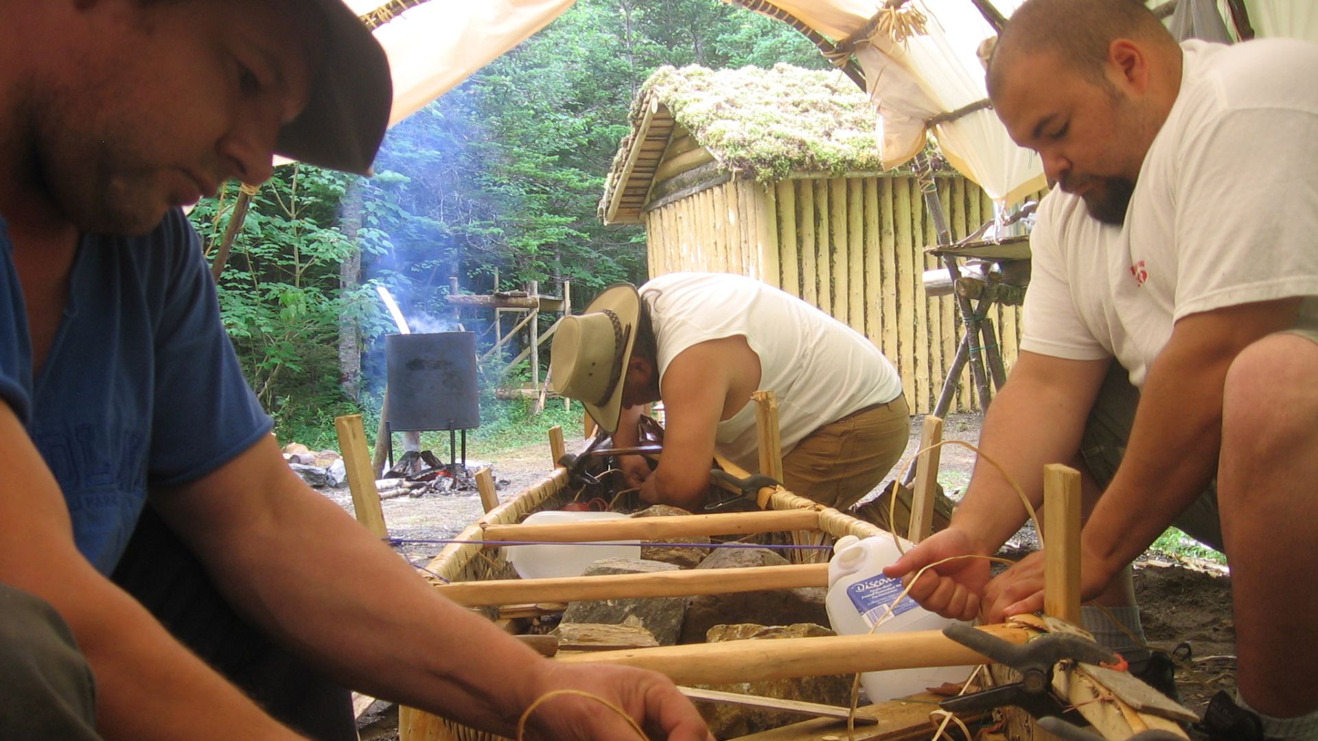 Men making a birch bark canoe in Conne River, Newfoundland, in 2009