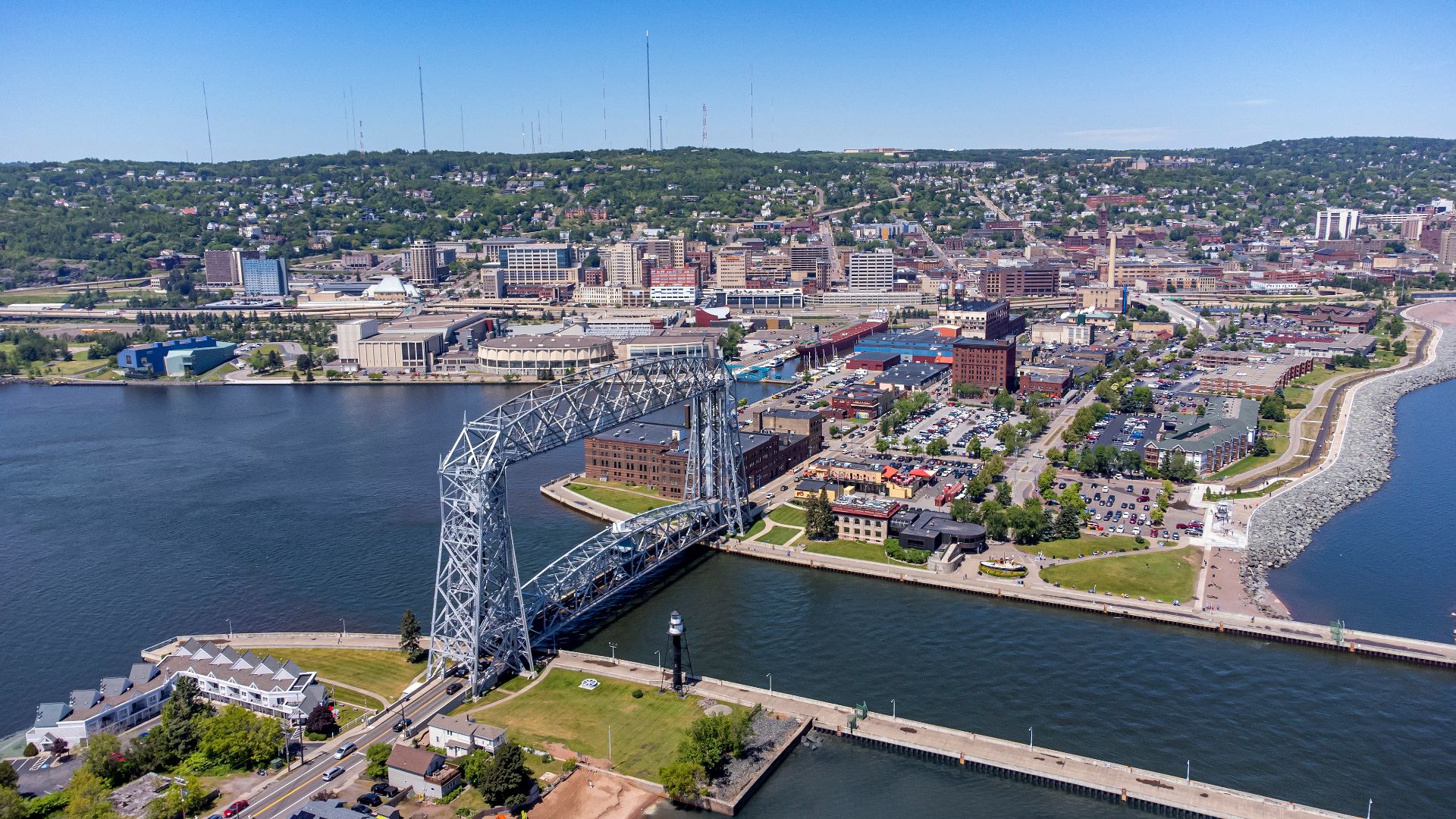 Aerial image capturing the Duluth Aerial Lift Bridge, Canal Park and downtown Duluth. Taken over Lake Superior June 2021