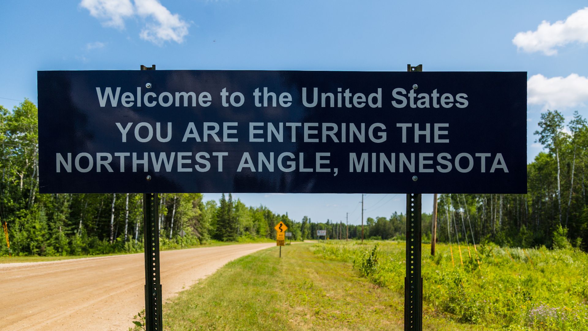 A sign marks the entrance to the Northwest Angle of Minnesota, from rural Manitoba, Canada.