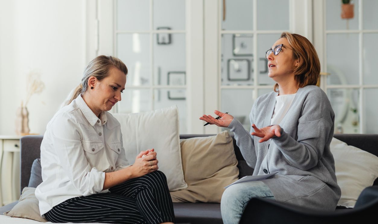 Two women having a conversation in a bright