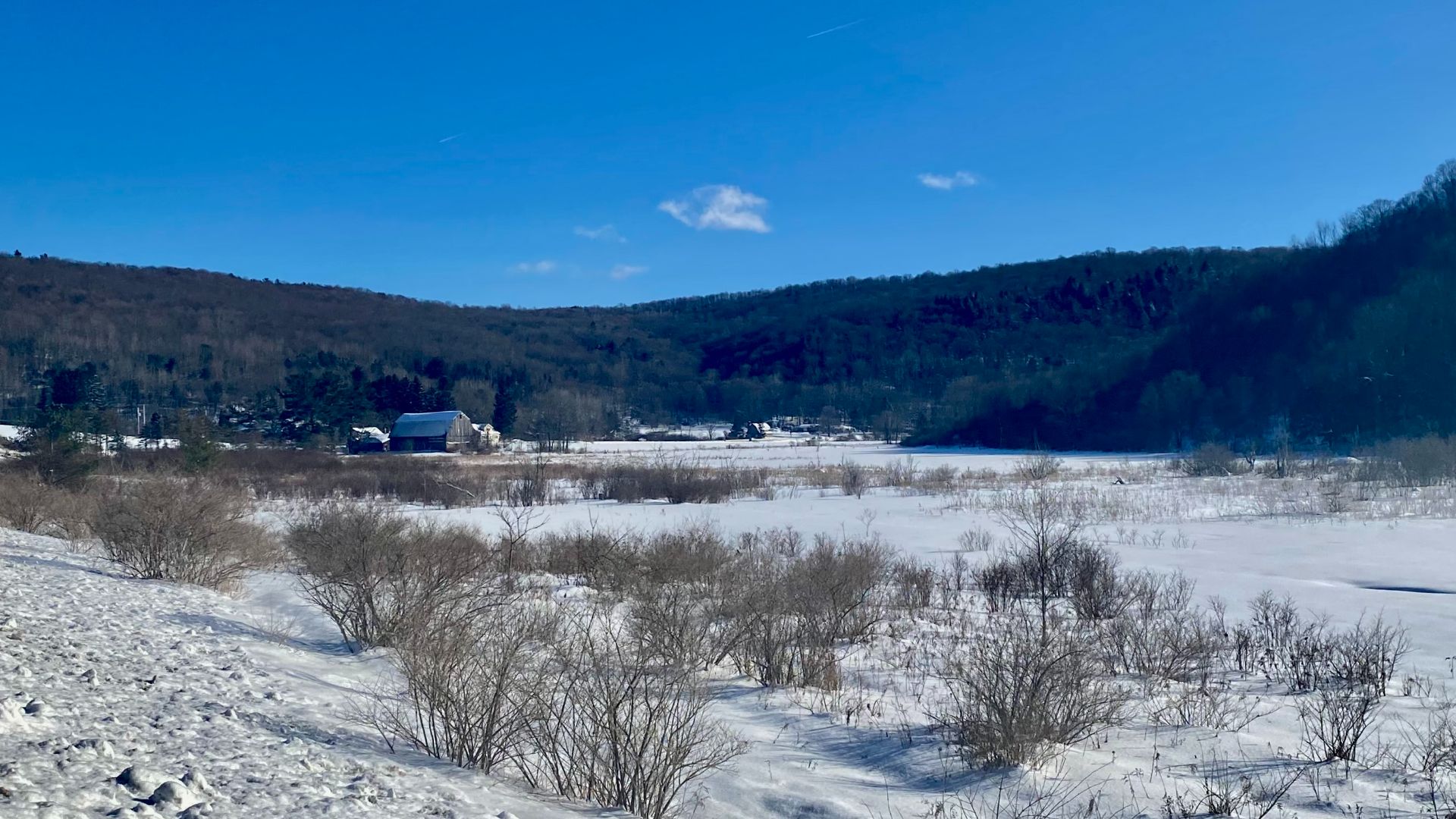 A wintry pastoral view in the town of Ellicottville, New York, looking southward from the side of U.S. Route 219 as it meanders through a scenic valley. As seen in February 2022.