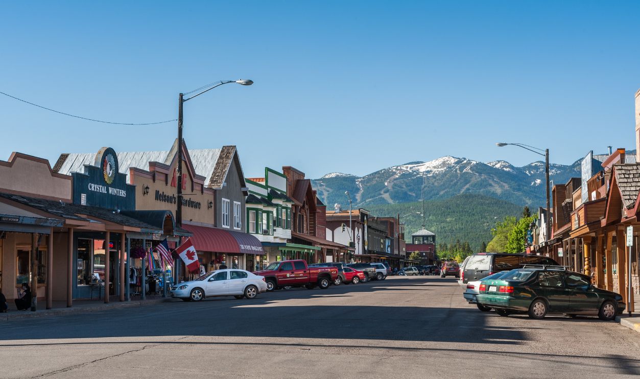Whitefish, Montana, USA - May 29, 2009 : view of the main street of Whitefish city with houses, stores, cars