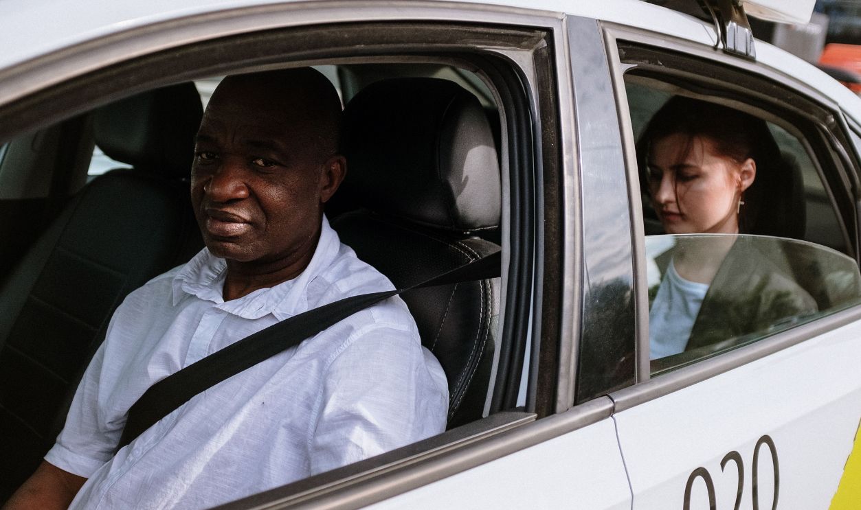 A taxi driver and passenger in a city