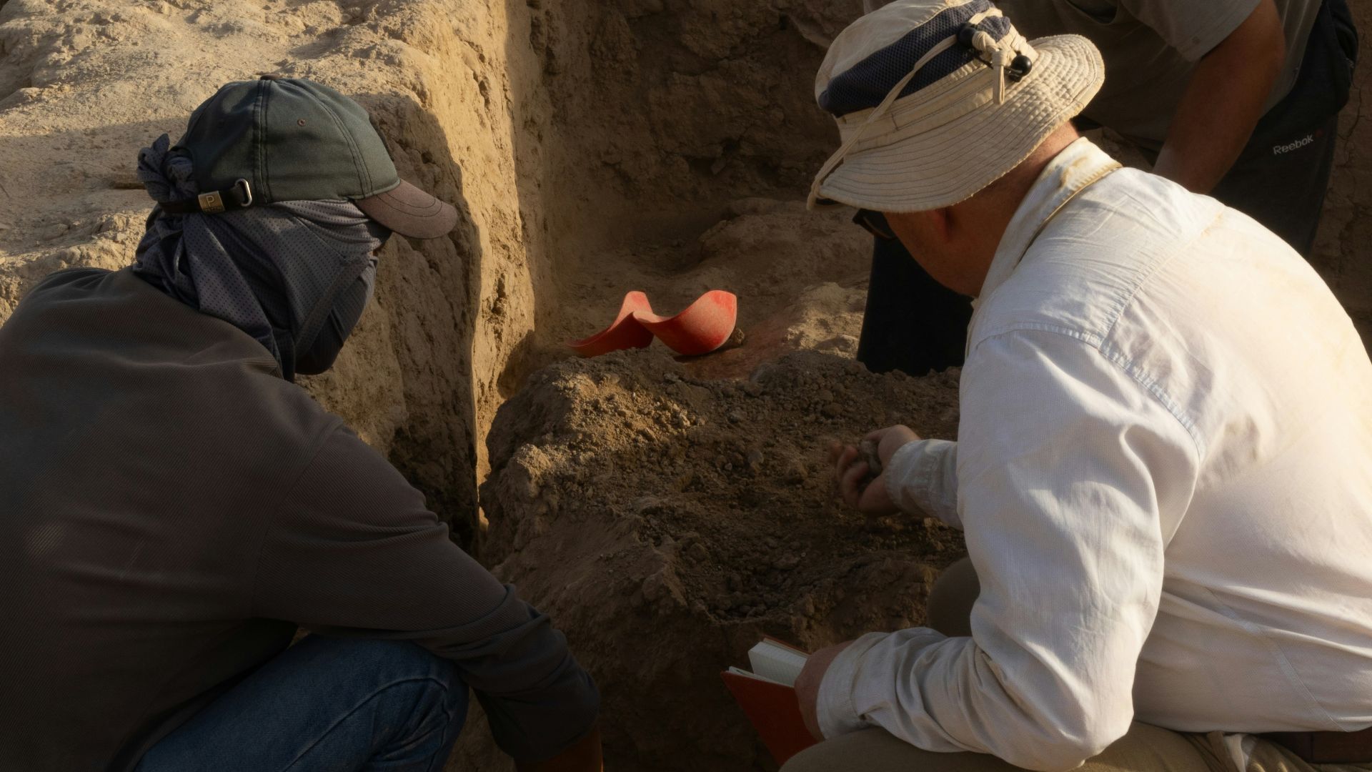 A group of men kneeling down next to each other