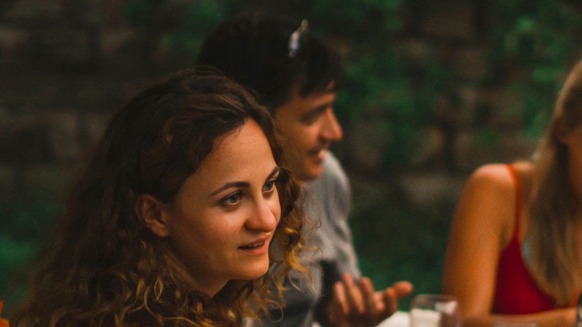 a group of people sitting around a table eating food