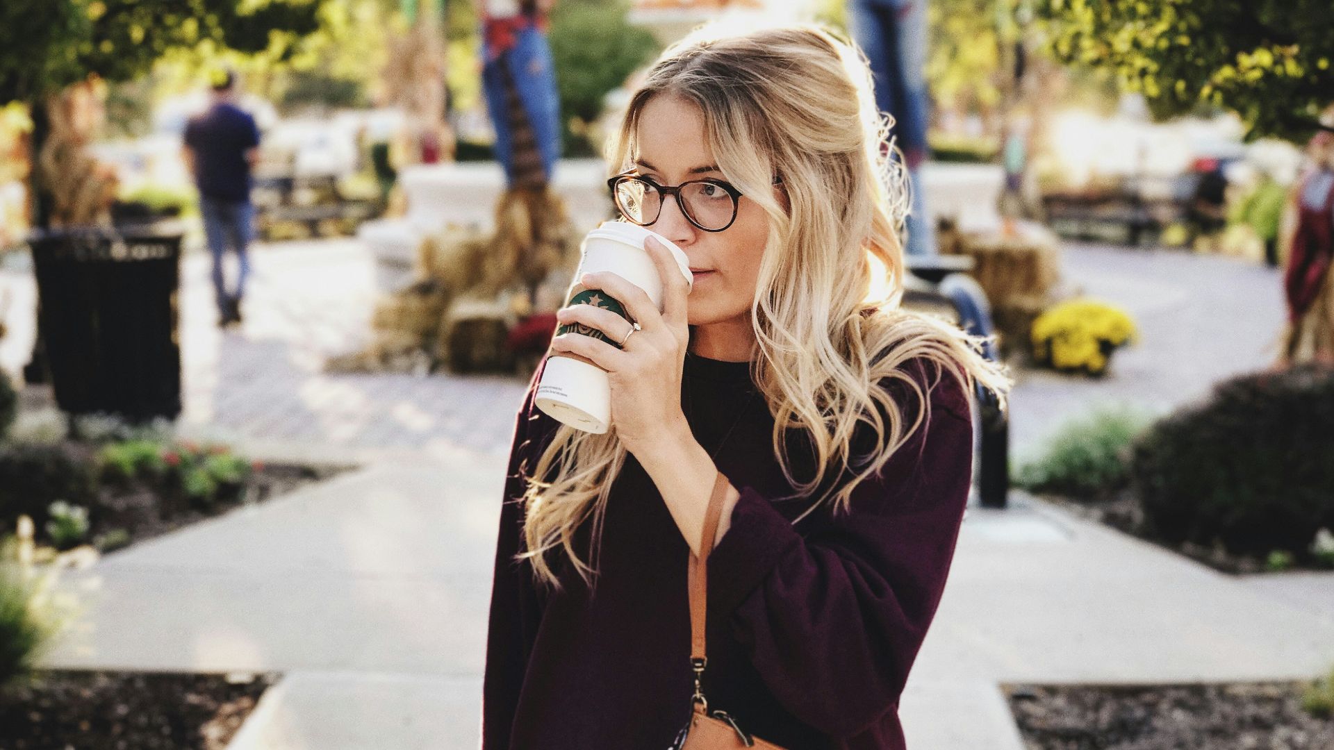 woman drinking on white cup
