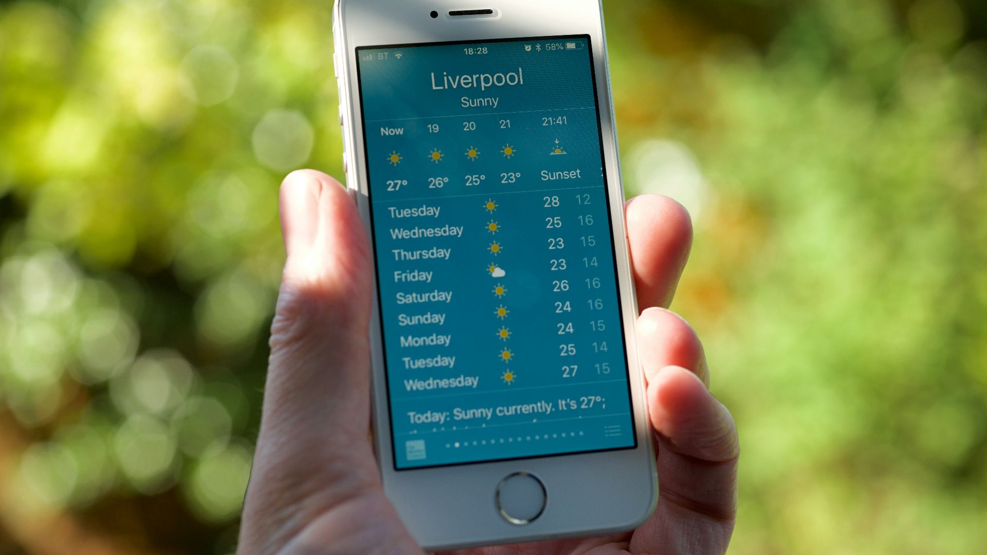 person holding turned on silver iPhone 5s displaying liverpool