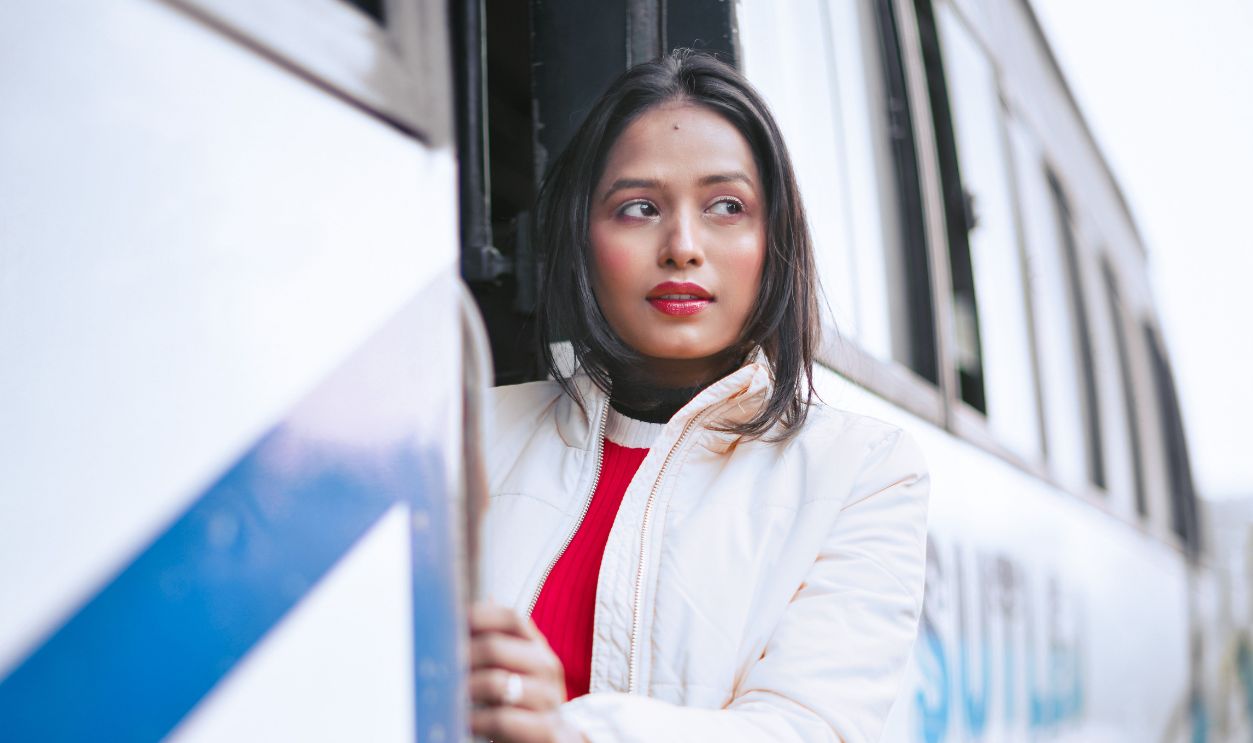 Asian woman standing at bus entrance