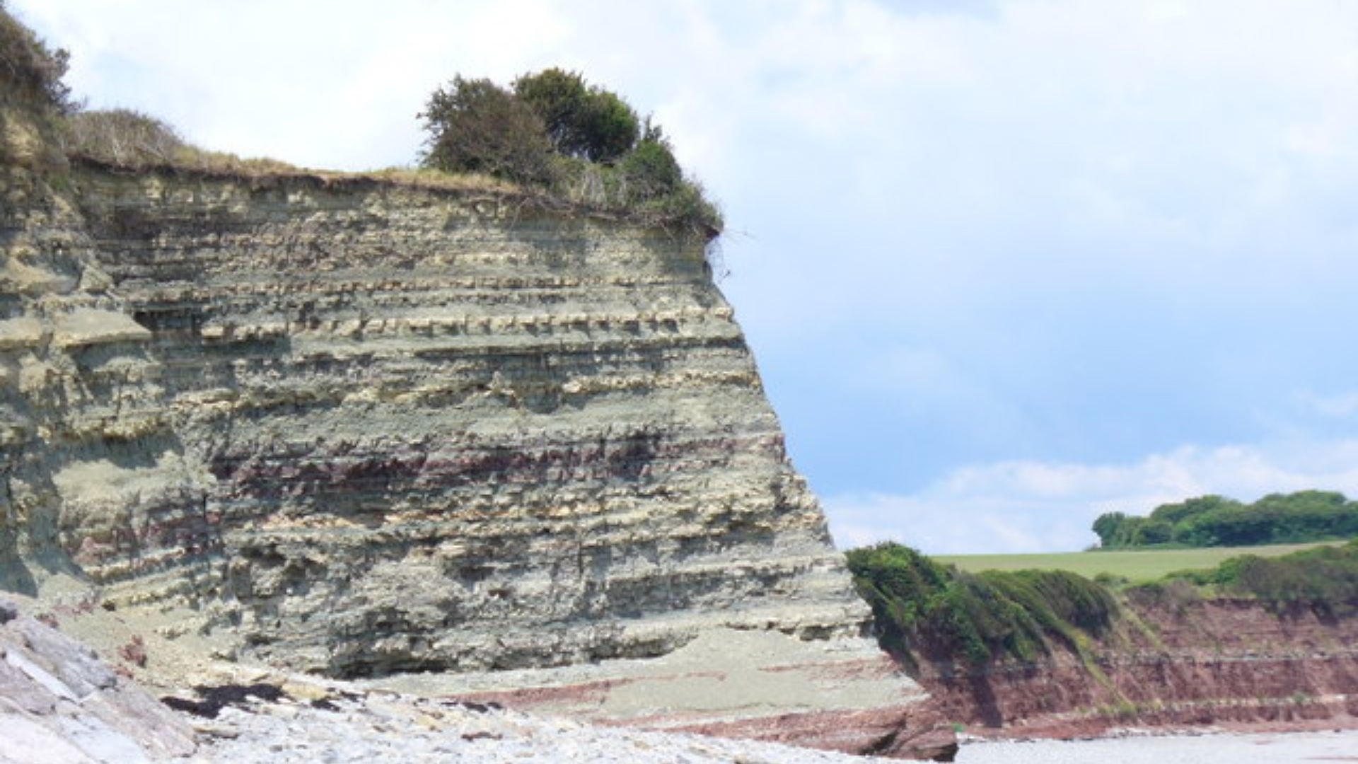 Cliffs at Lavernock Point Red and grey cliffs of mudstone and blue lias tower over the cobbly beach at Lavernock. Note the clearly banded strata.
http://www.bbc.co.uk/wales/southeast/sites/walks/pages/lavernock.shtml