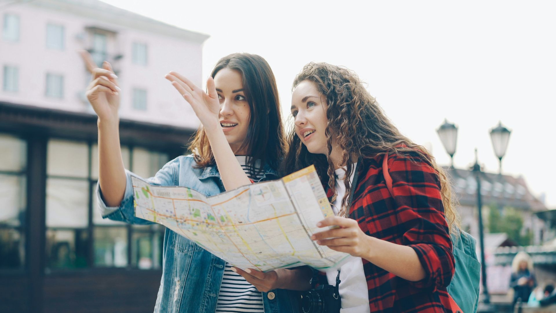 Two women use a map to find directions.
