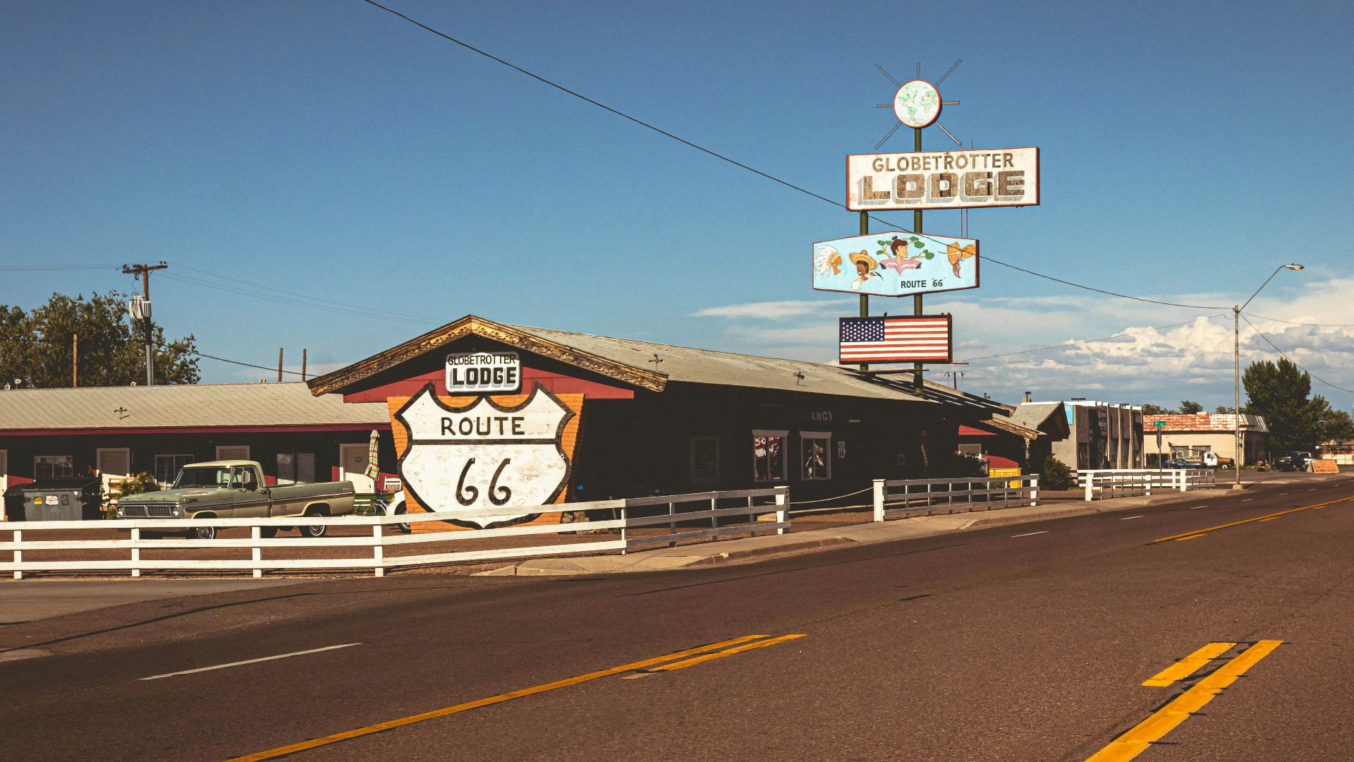 A road with a sign and a building on the side of it