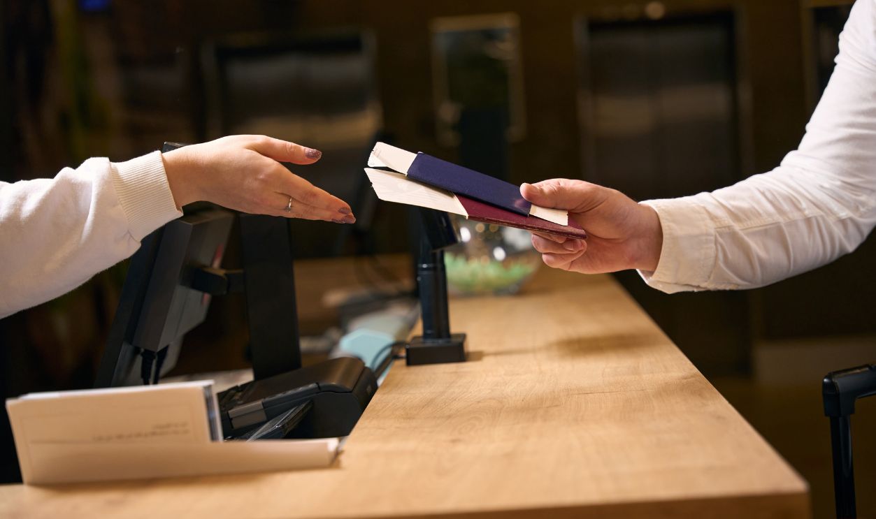 Male guest is checking into at hotel