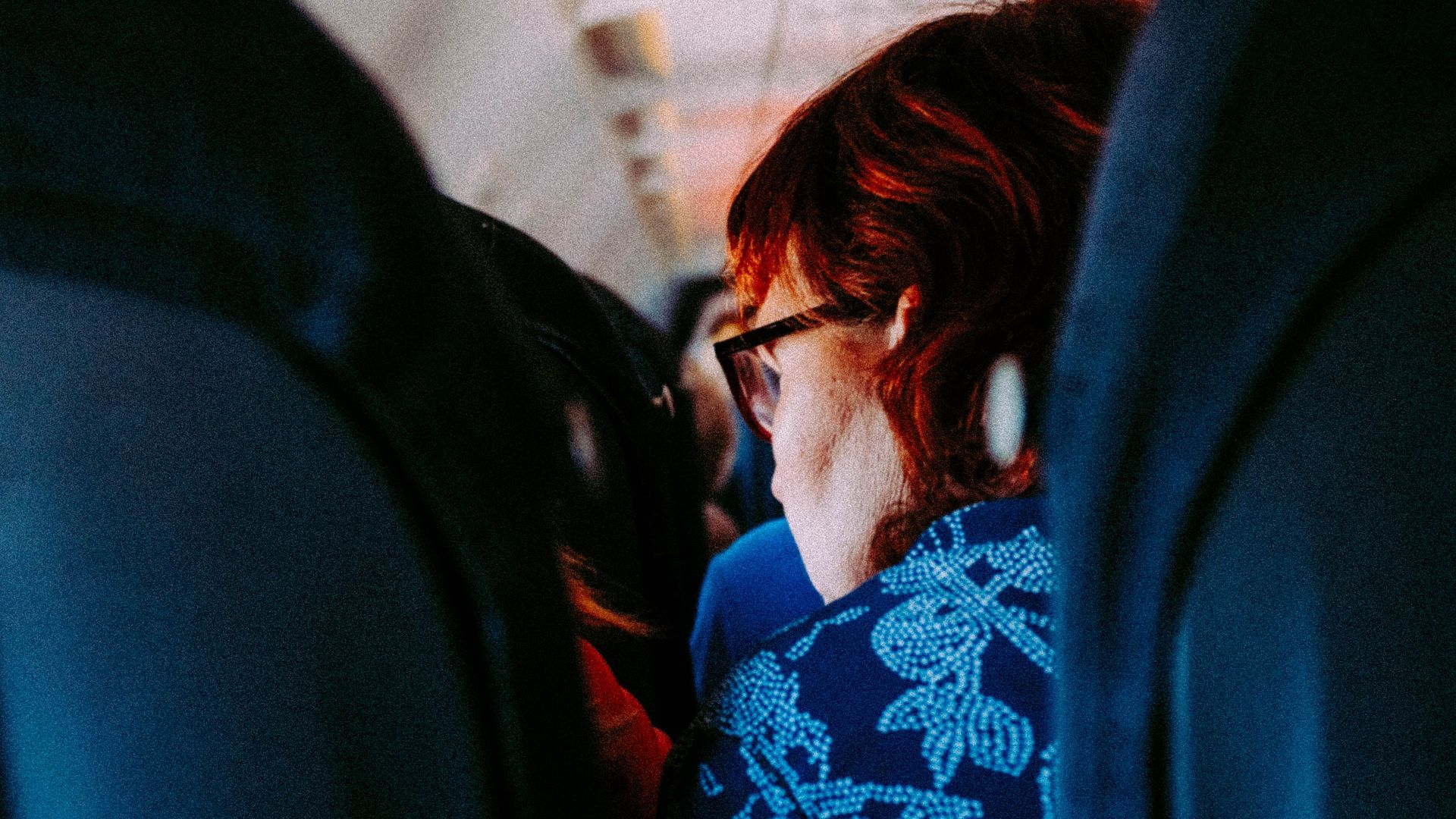 Woman sitting in an airplane cabin interior during daytime travel.