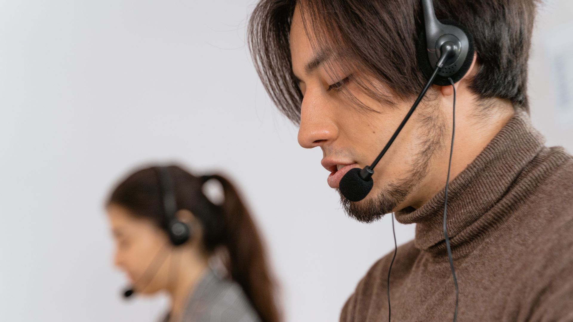 Focused call center employees wearing headsets, assisting customers with exceptional service.