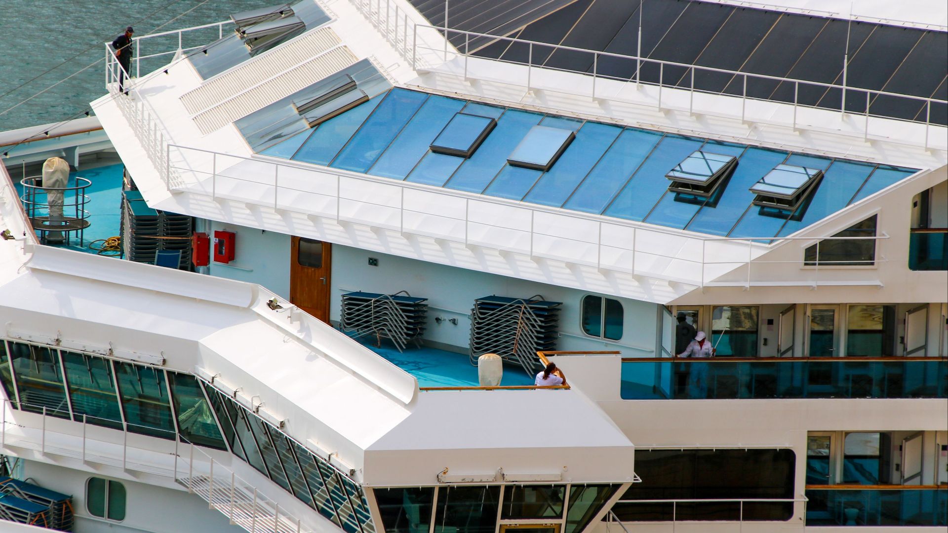 Close-up aerial view of a cruise ship deck highlighting modern design elements.