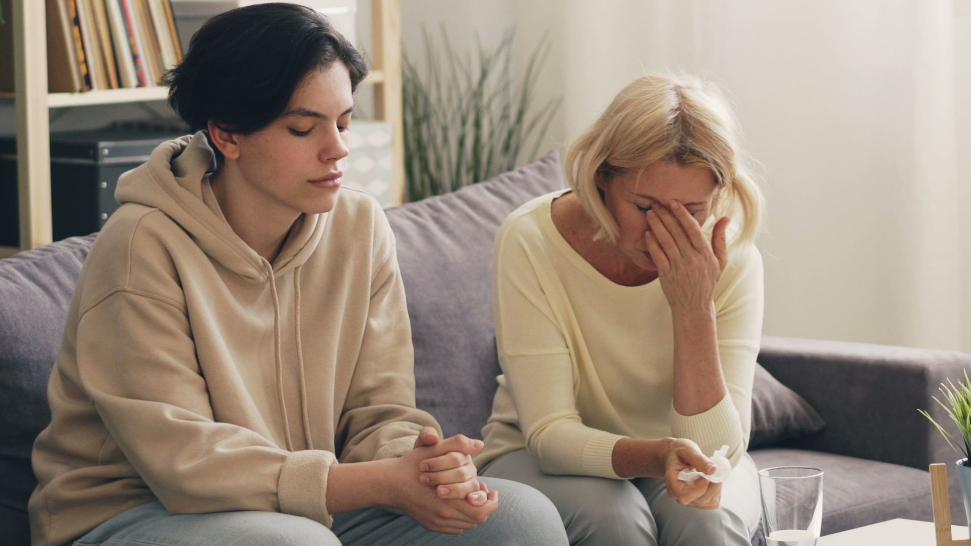 Emotional family therapy session with a therapist indoors, conveying connection and support.